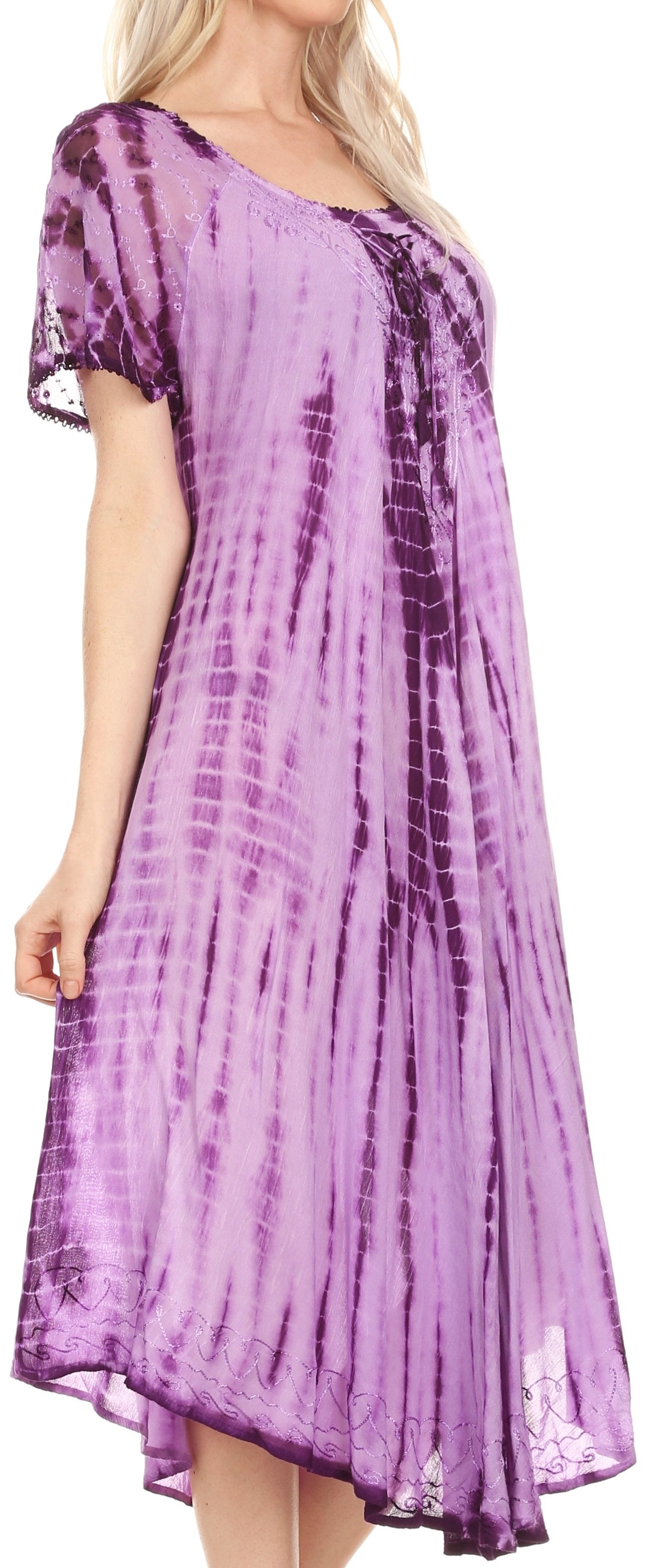 Woman wearing a purple tie-dye dress with a plain background