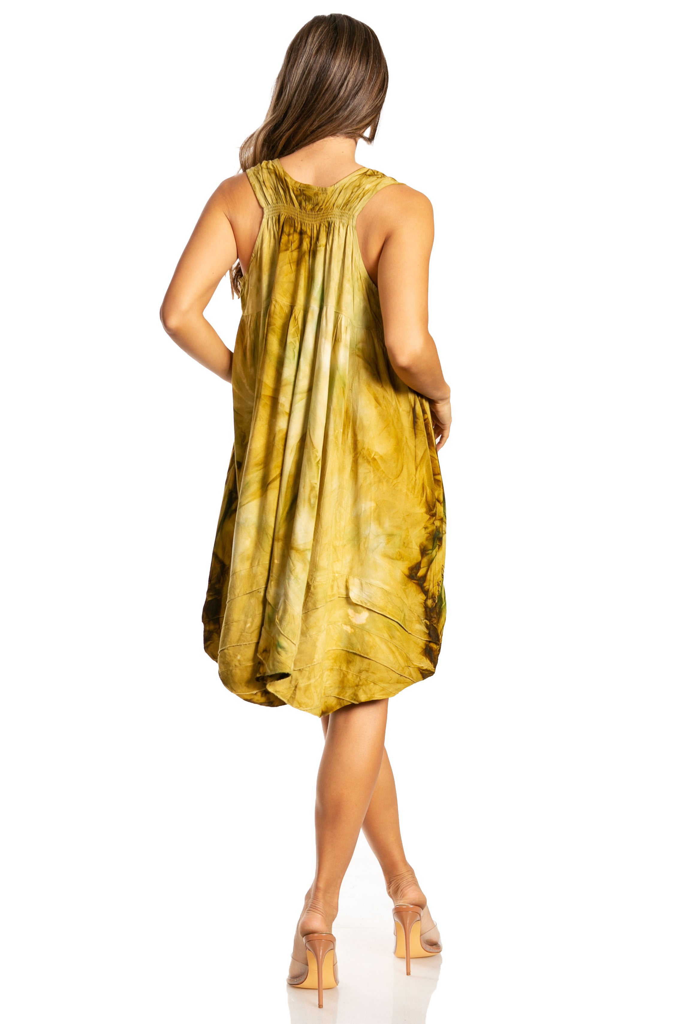 Woman wearing a yellow tie-dye dress on a white background