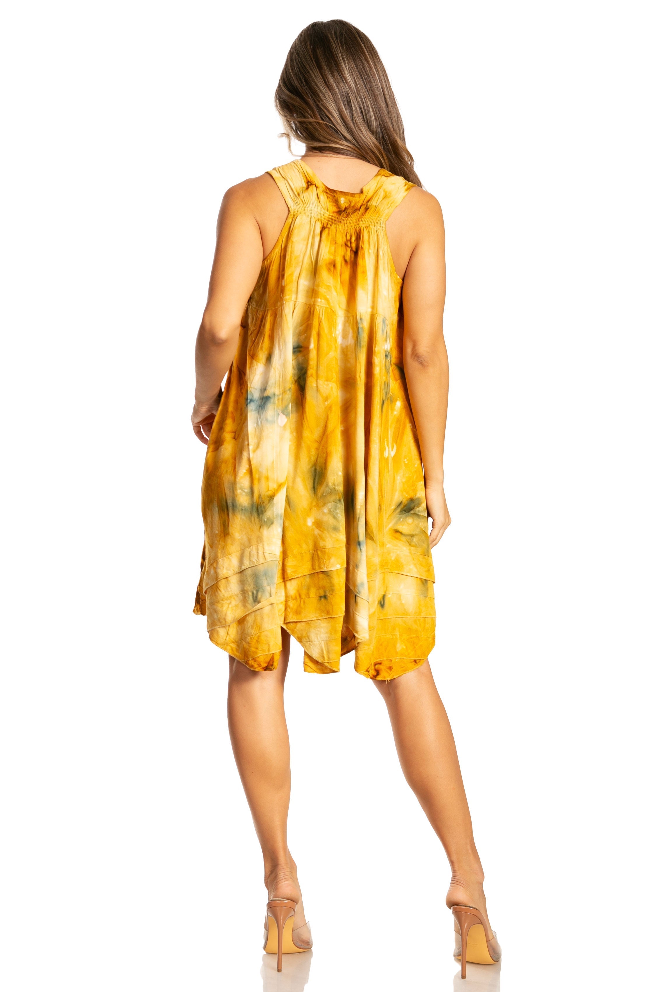 Woman wearing a yellow tie-dye dress on a white background