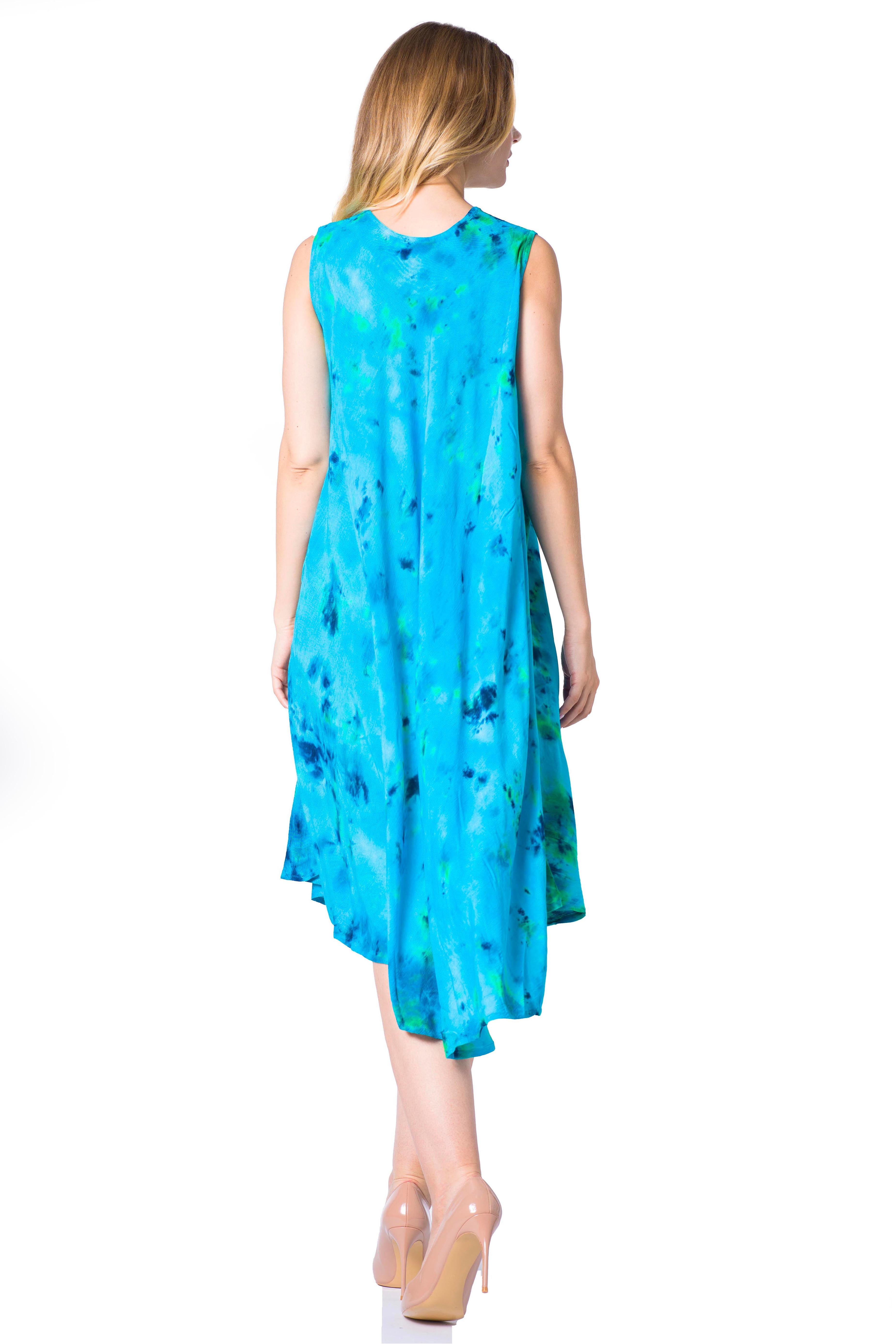 Woman wearing a blue dress with green patterns on a white background