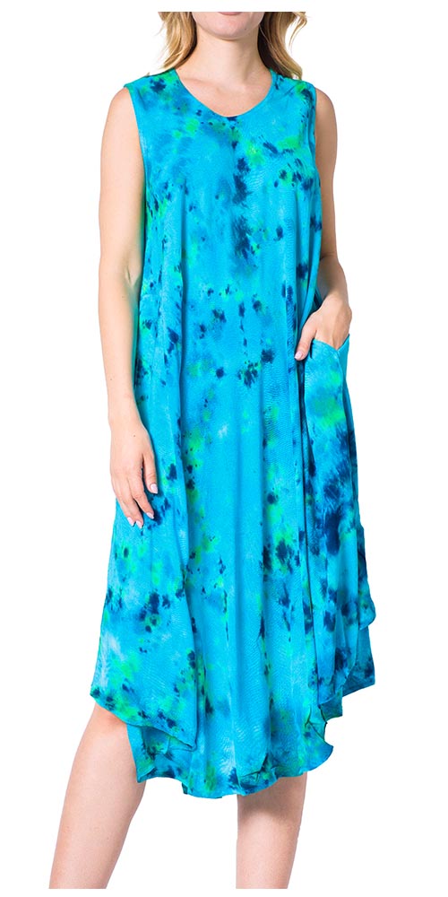 Woman wearing a blue sleeveless dress with green and black abstract pattern on a white background