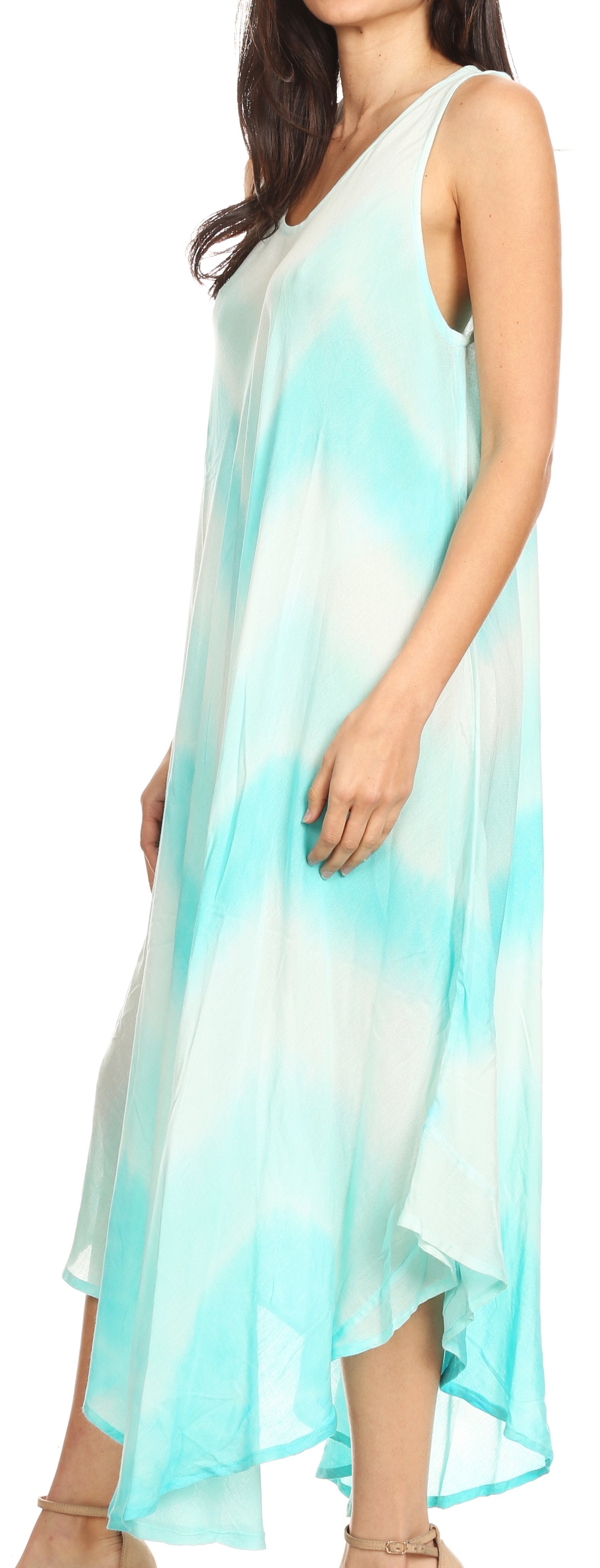 Woman wearing a sleeveless, light blue to white gradient dress.