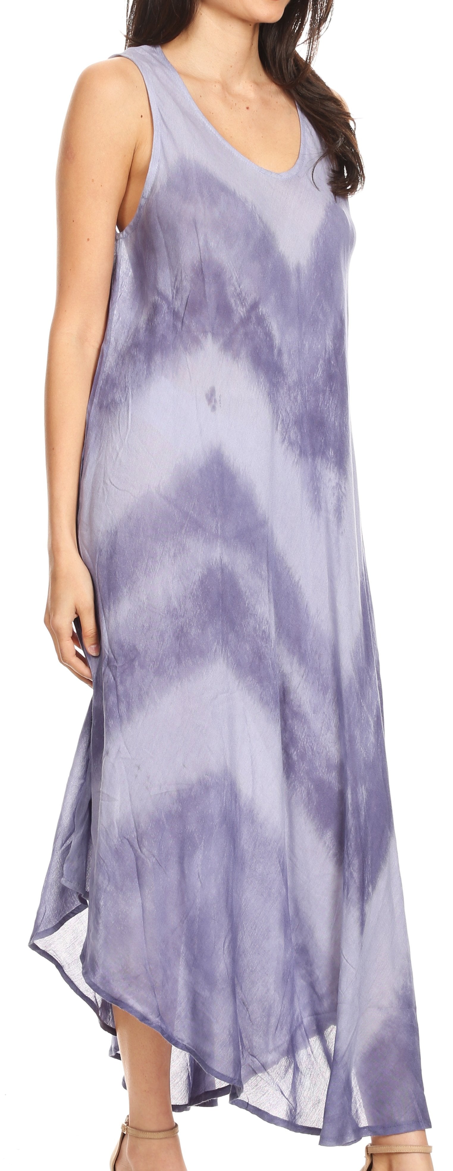 Woman wearing a sleeveless, tie-dye dress in shades of purple and blue.