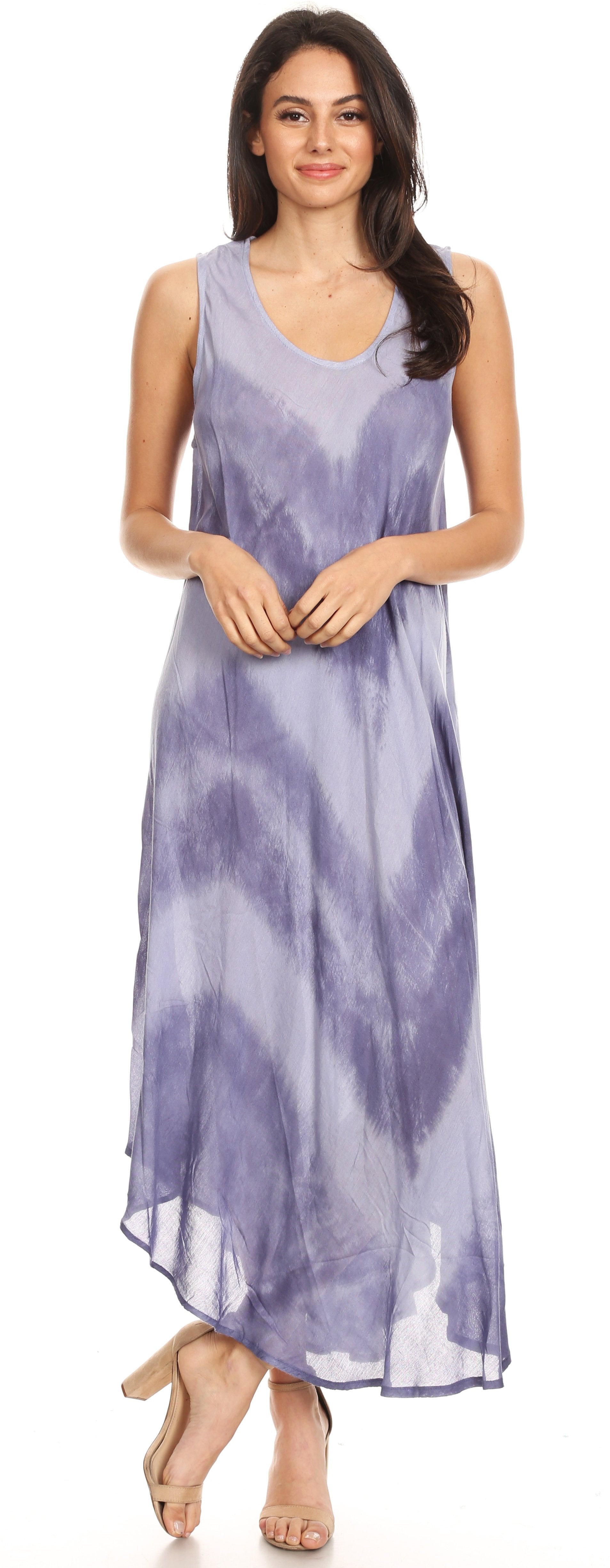 Woman wearing a sleeveless, long, tie-dye dress in a lavender and white pattern.