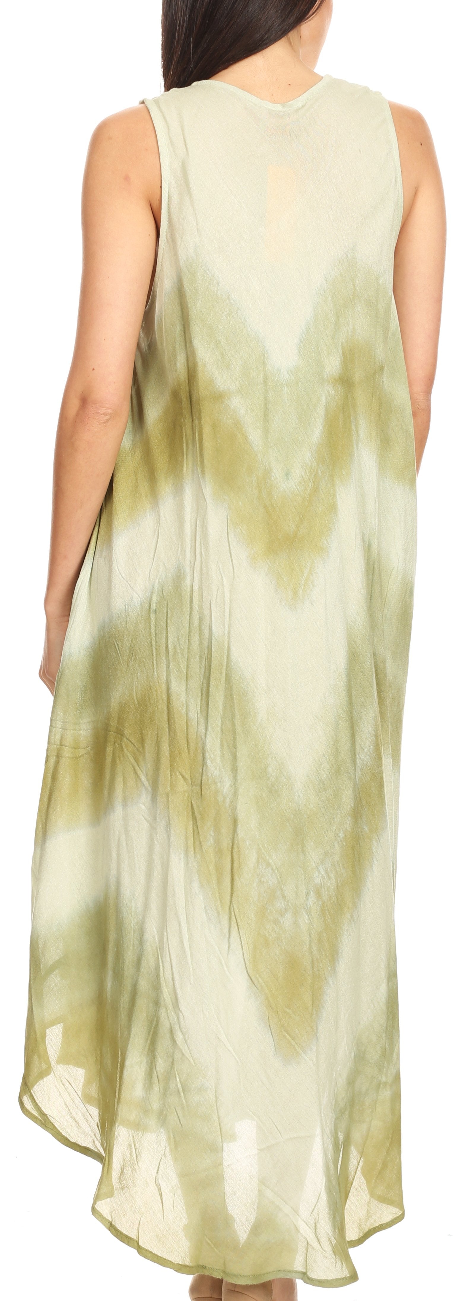 Woman wearing a sleeveless, light-colored dress with a tie-dye pattern.