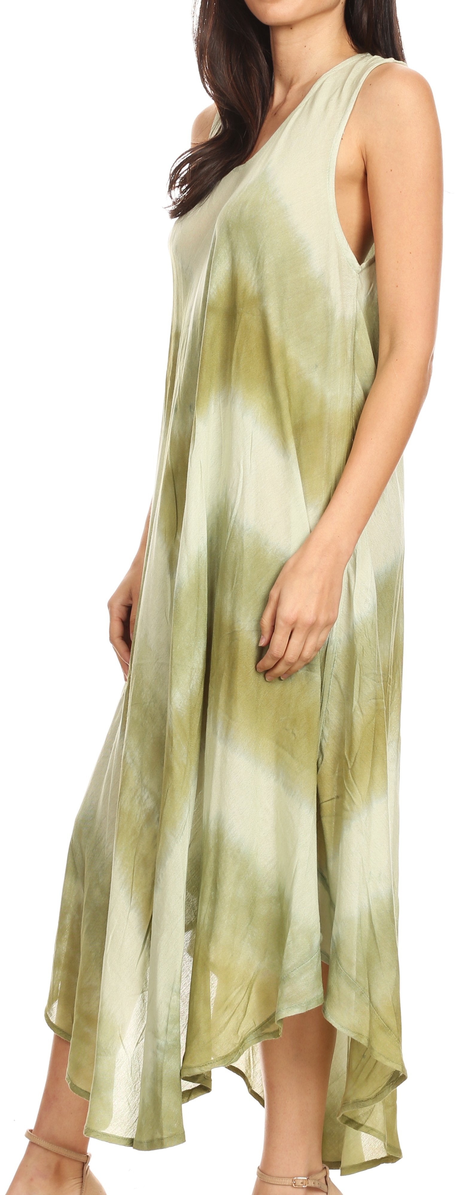 Woman wearing a sleeveless, light green and white tie-dye dress on a white background