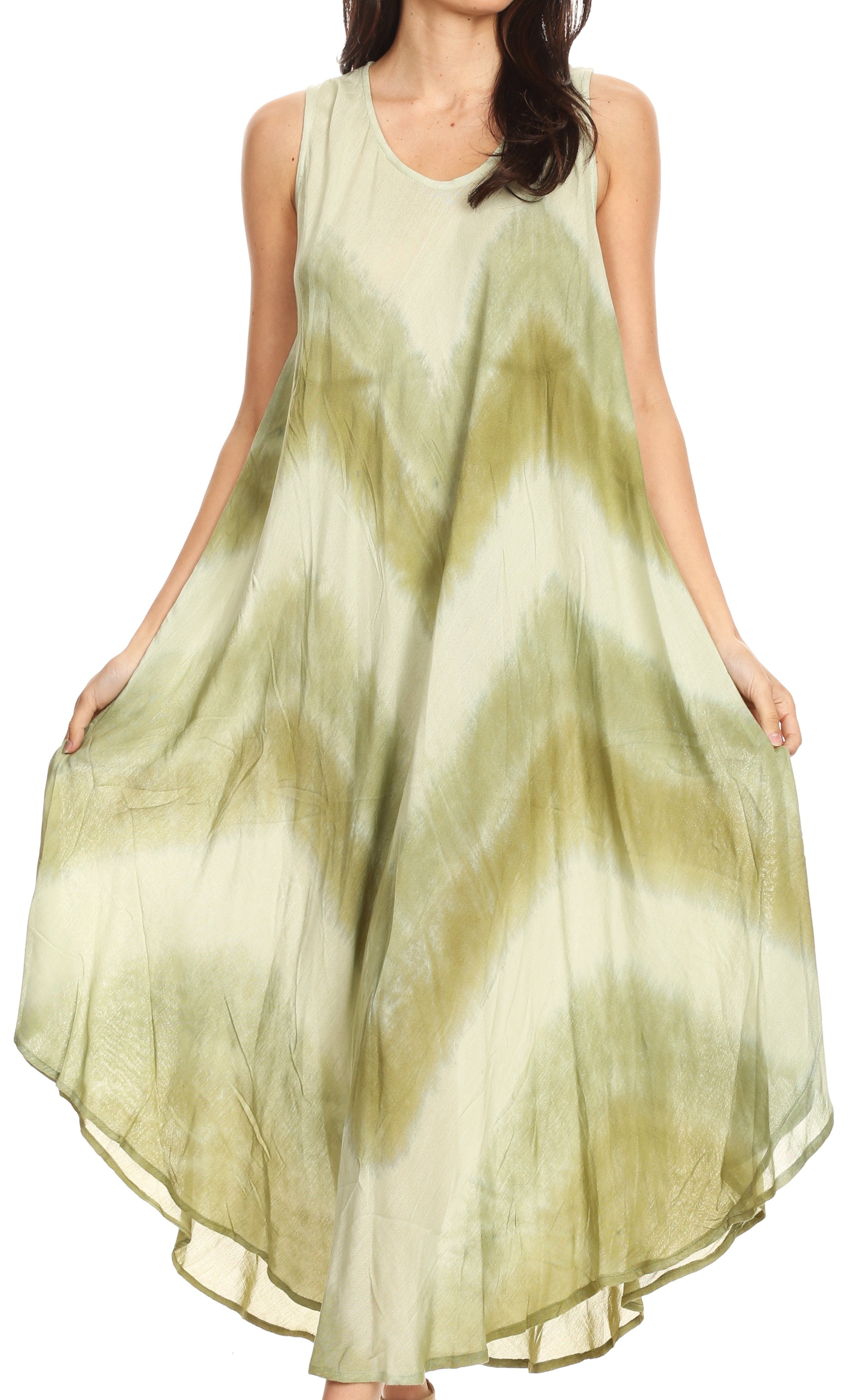 Woman wearing a sleeveless, light green dress with a white center on a white background