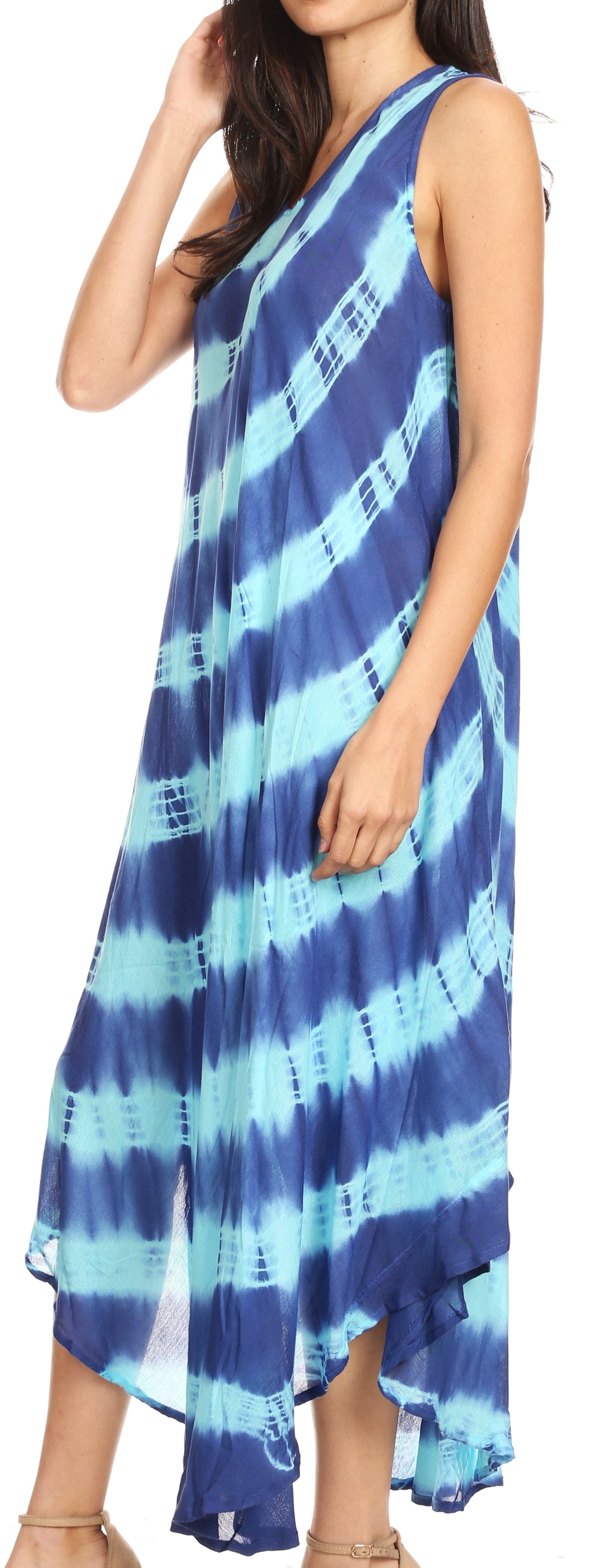 Woman wearing a blue and green tie-dye dress with a blurred background
