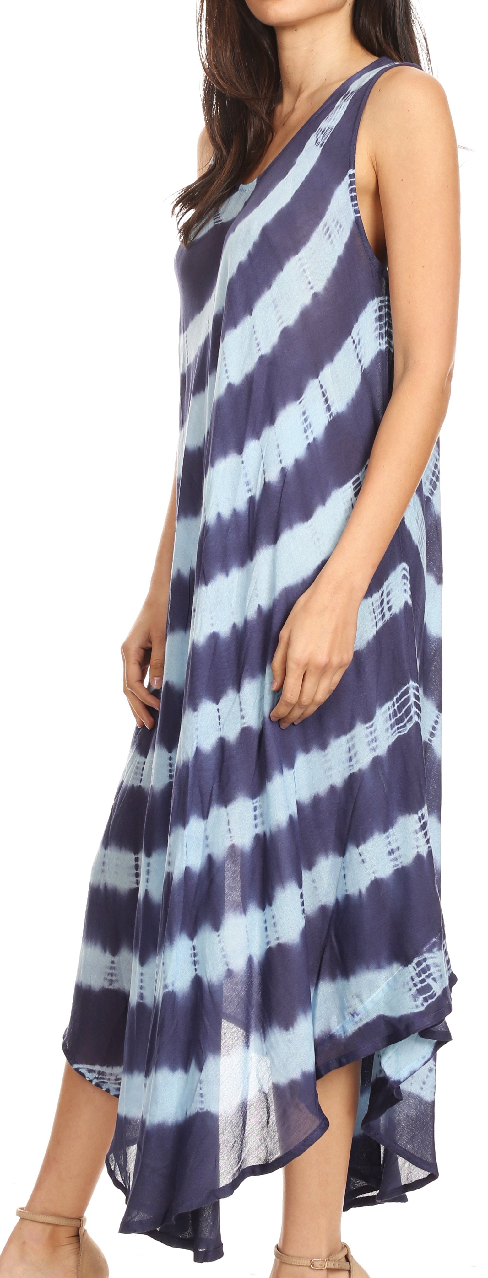 Woman wearing a sleeveless dress with blue and white striped pattern on a plain background