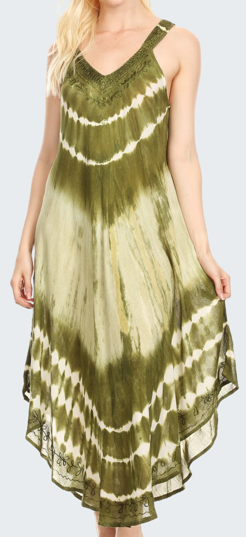 Woman wearing a tie-dye dress with green and white pattern on a plain background