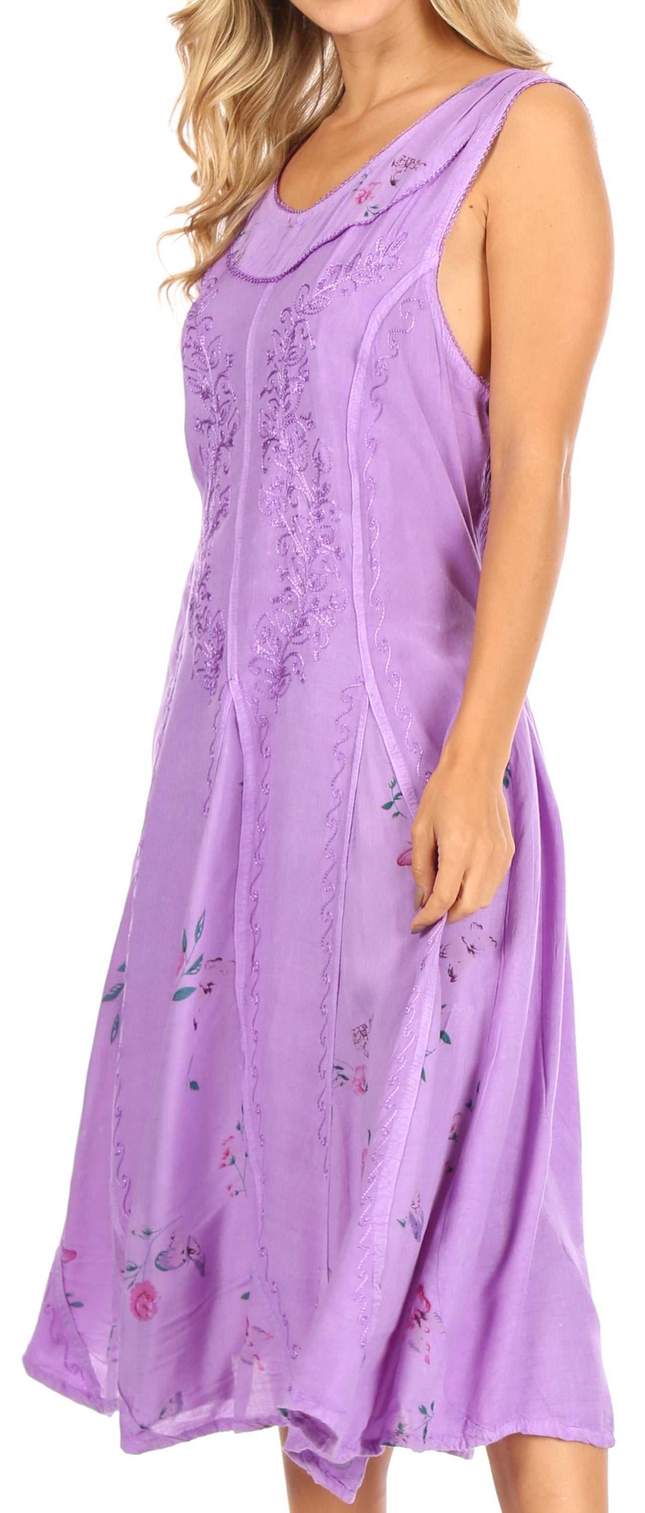 Woman wearing a purple sleeveless dress with floral patterns on a white background