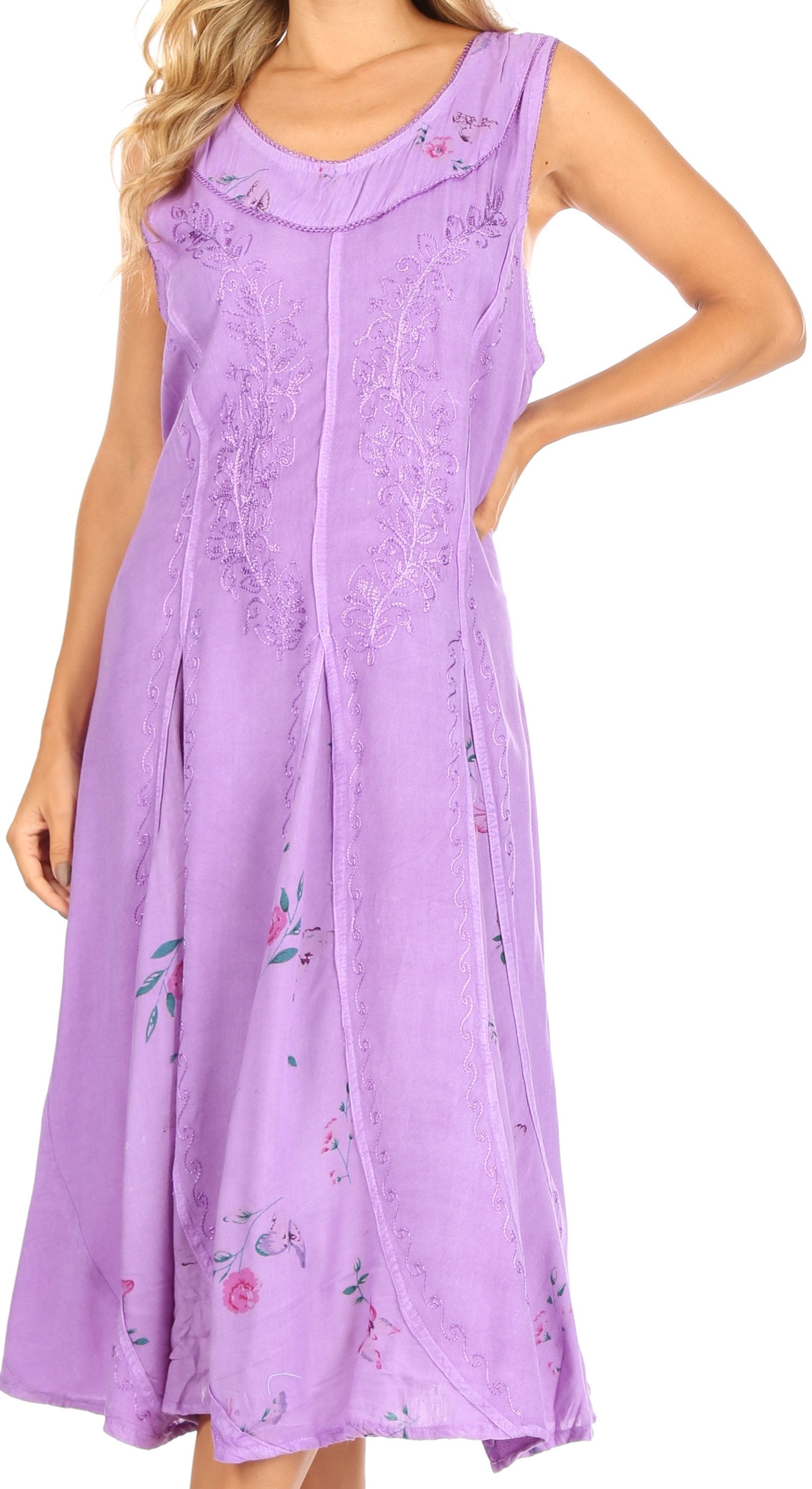Woman wearing a purple sleeveless dress with floral embroidery on a white background