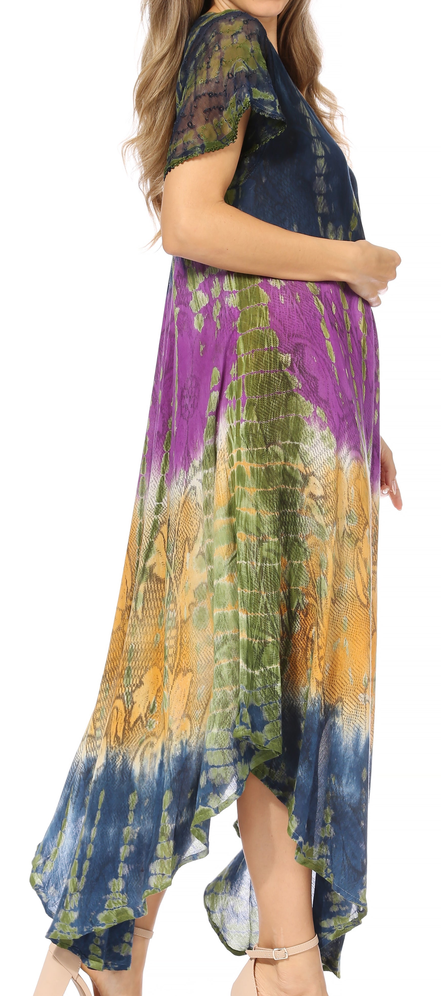 Woman wearing a tie-dye dress with a colorful pattern on a white background