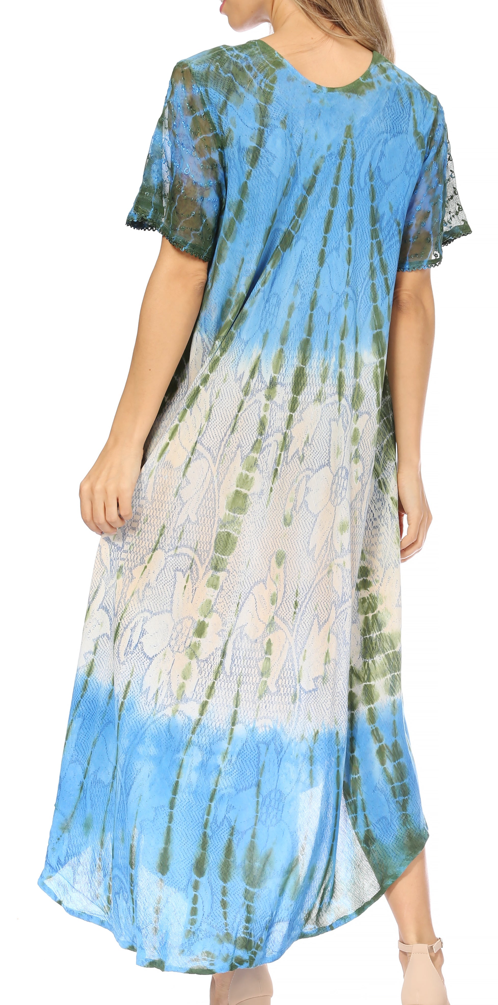 Woman wearing a tie-dye dress with blue, green, and white patterns on a white background