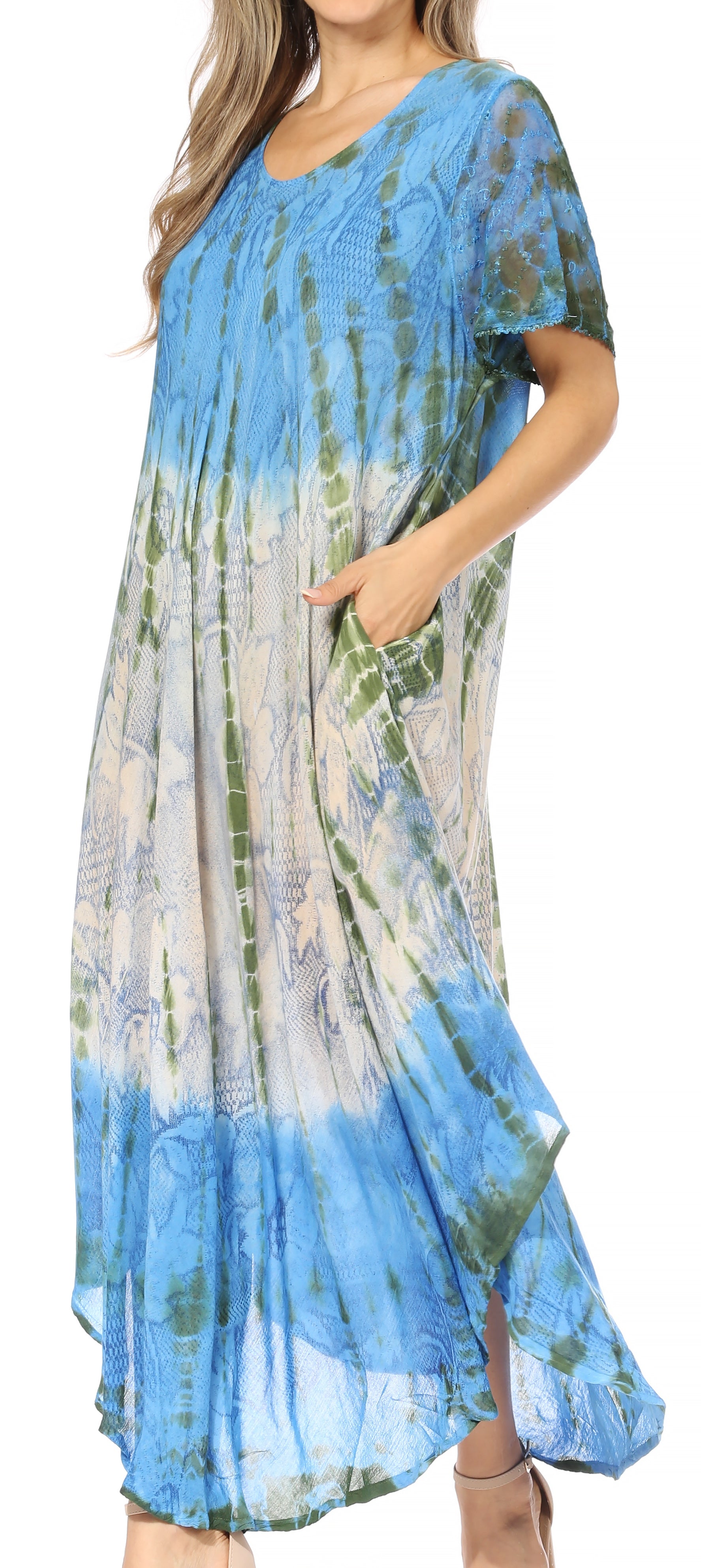 Woman wearing a blue and green tie-dye dress with a plain background