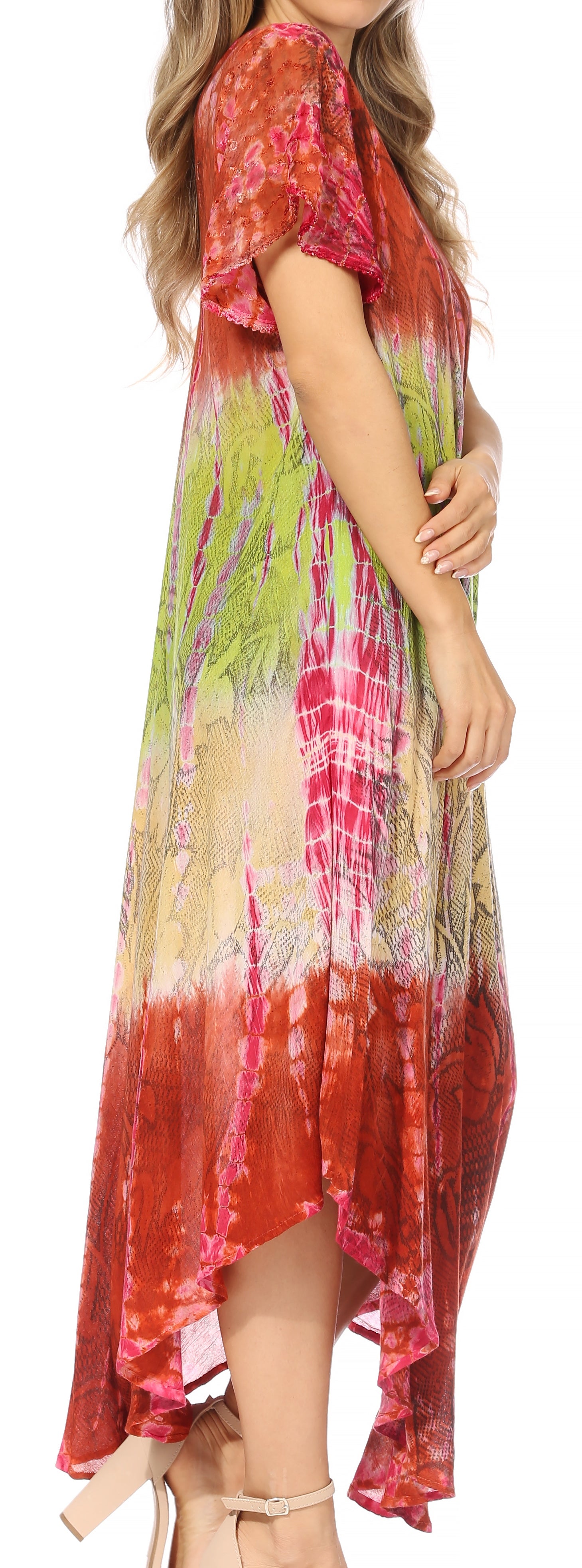 Woman wearing a colorful tie-dye dress with a pattern of red, green, and yellow.