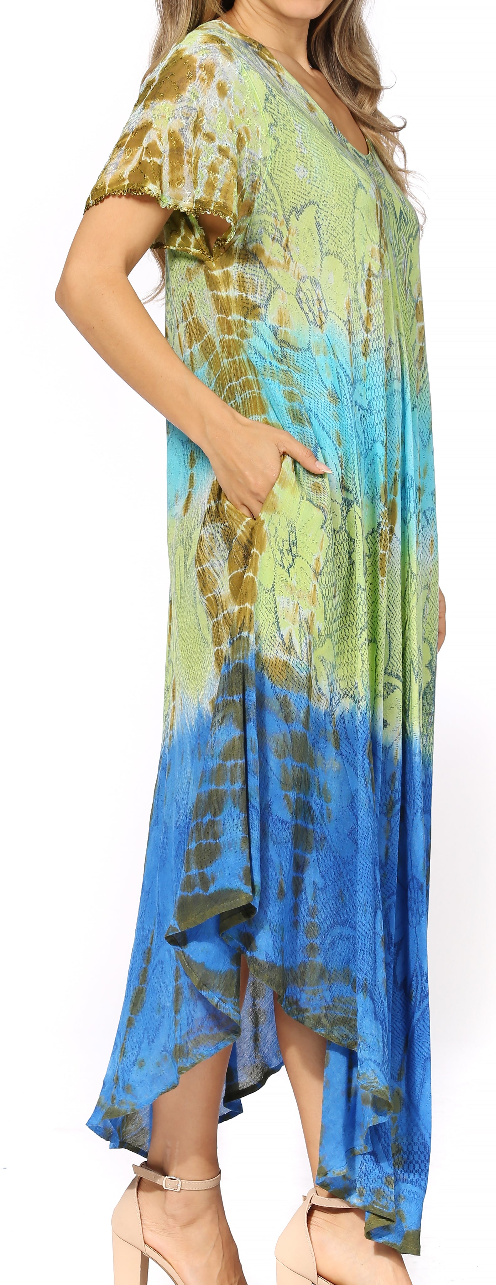 Woman wearing a tie-dye dress with a gradient from green to blue on a white background