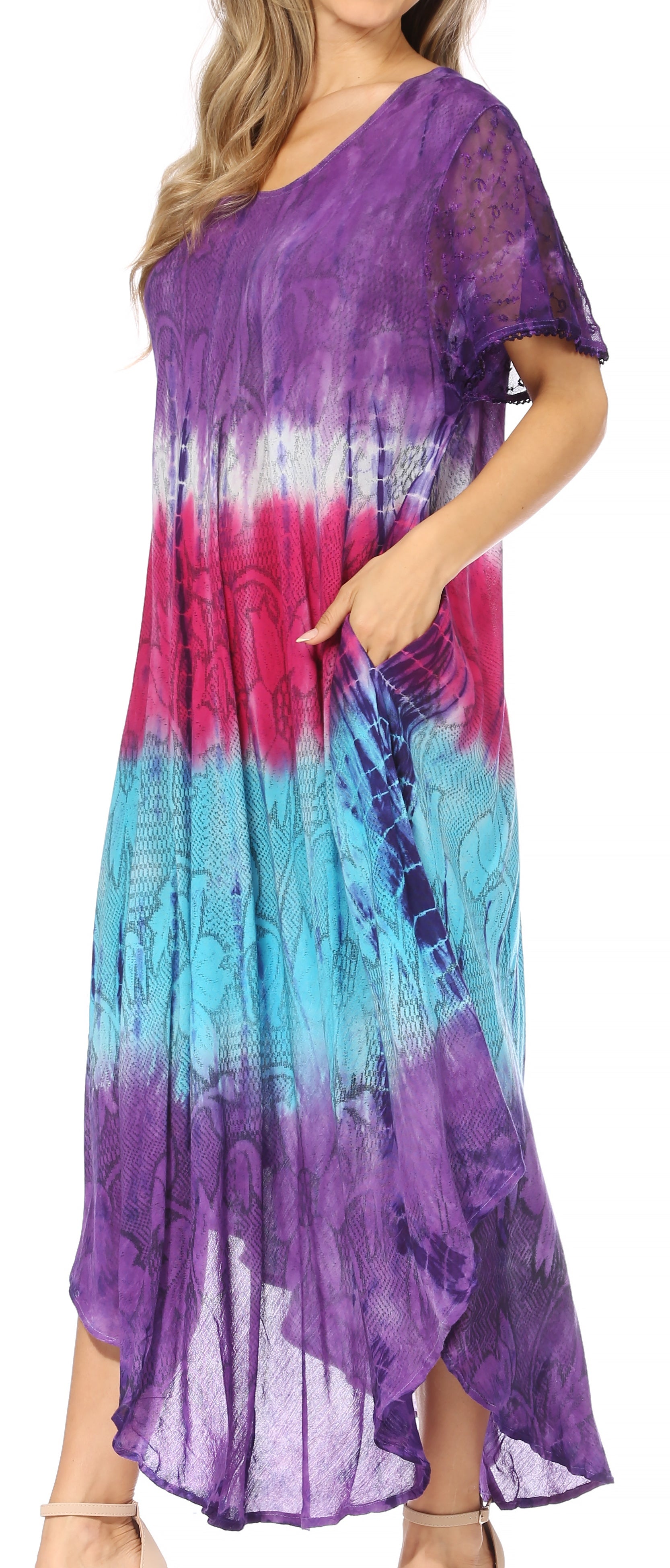 Woman wearing a tie-dye dress with a gradient of purple, pink, and blue.