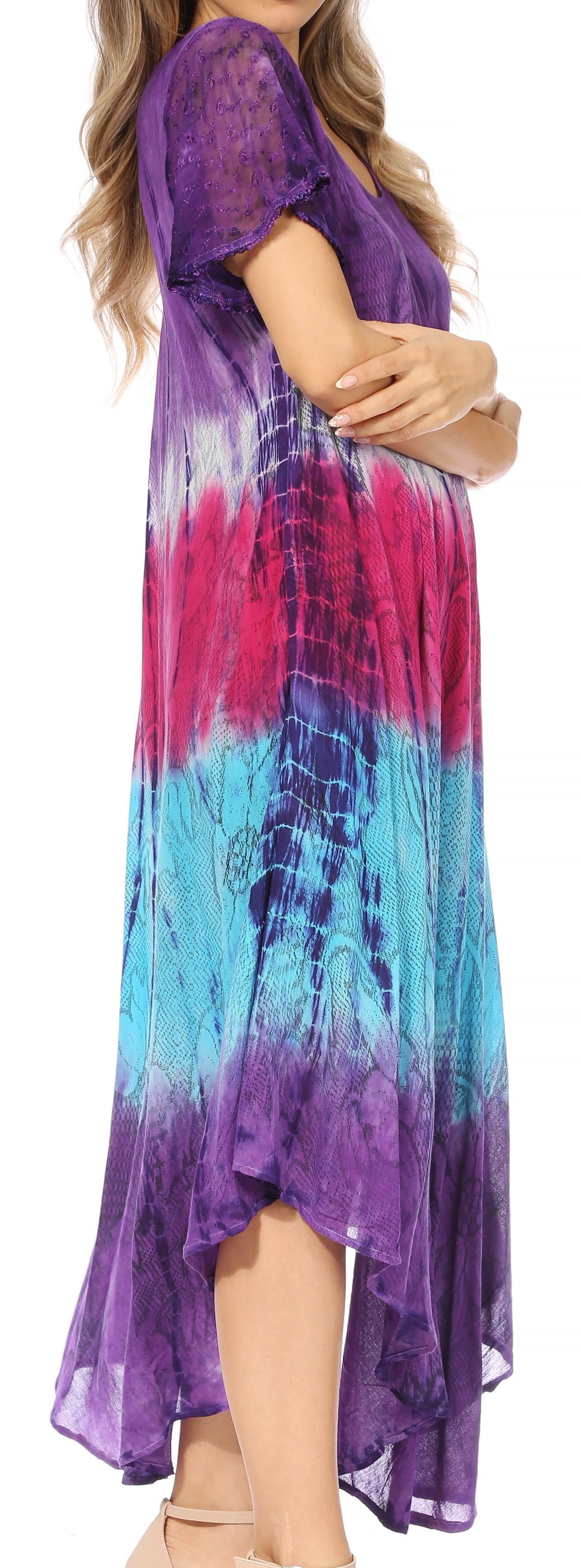Woman wearing a tie-dye dress with purple, pink, and blue colors.