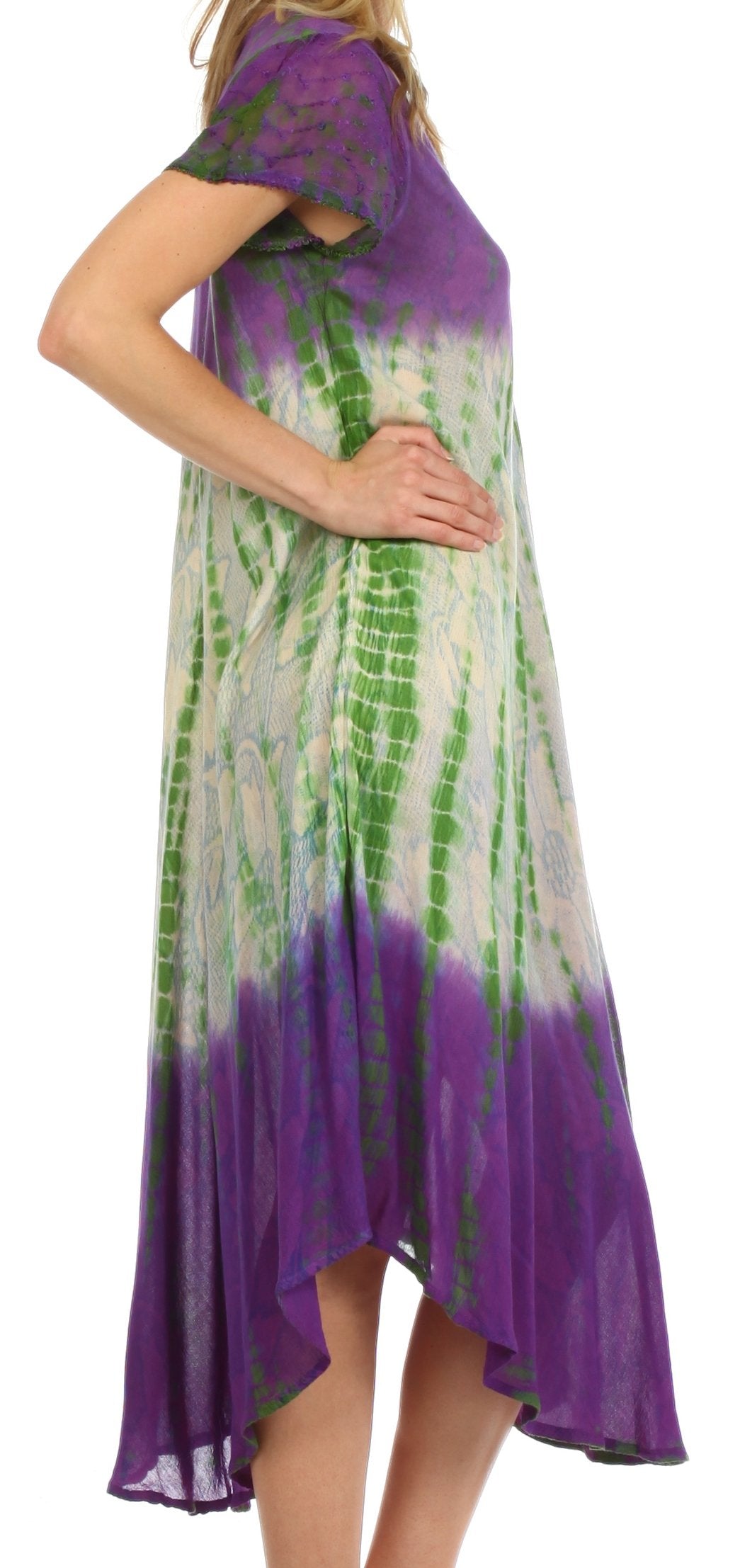 Woman wearing a tie-dye dress with purple and green patterns on a white background