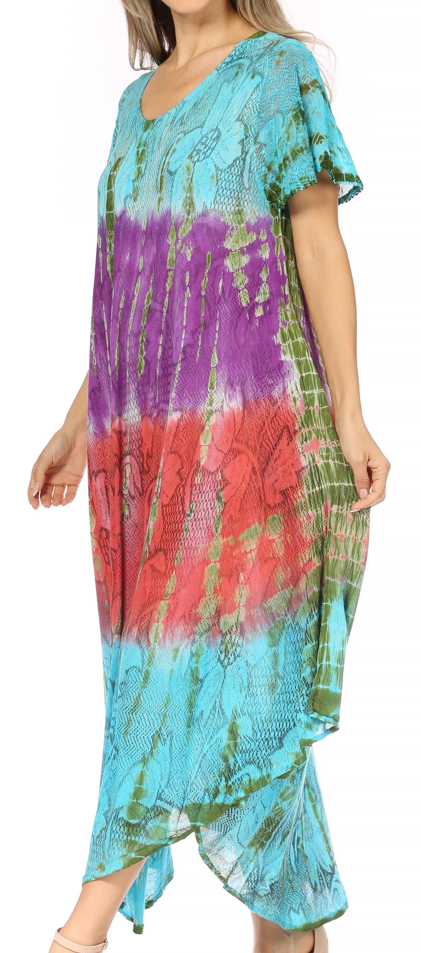 Woman wearing a colorful tie-dye dress with short sleeves and an open front.