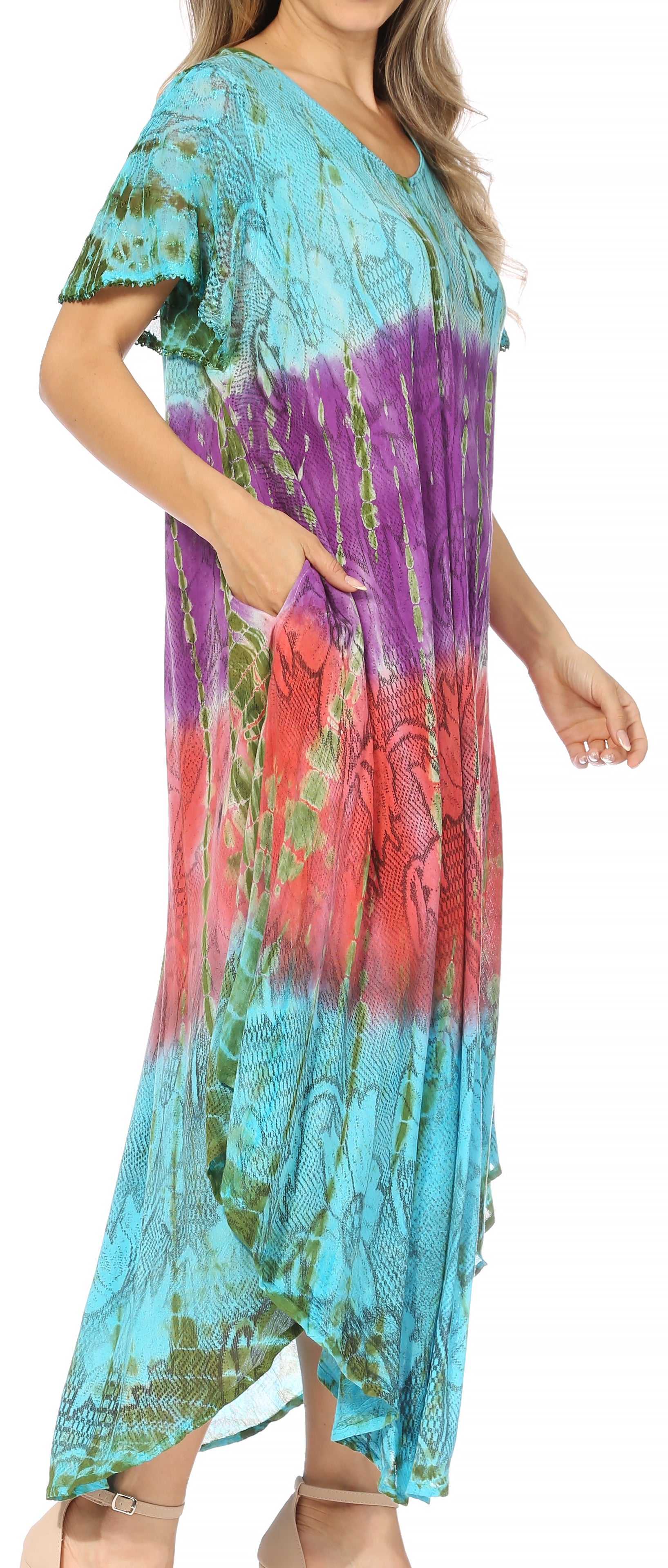 Woman wearing a colorful tie-dye dress with a gradient of blue, purple, and pink.