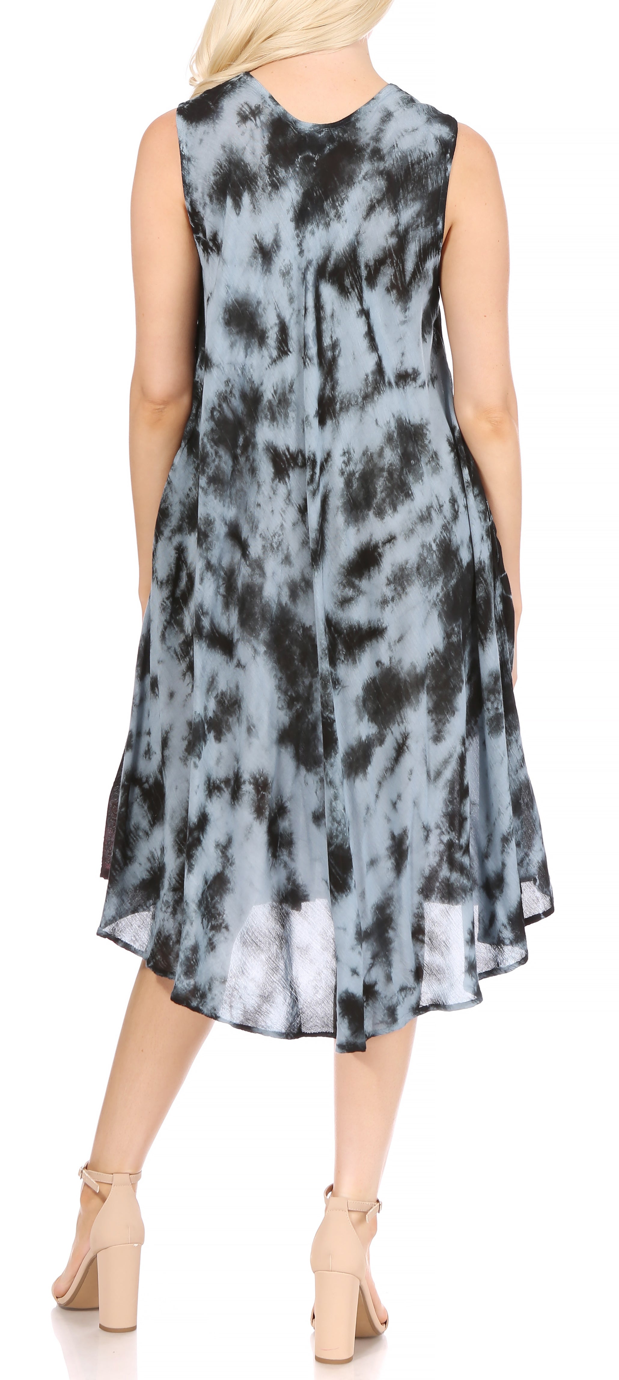 Woman wearing a sleeveless dress with a tie-dye pattern on a plain background