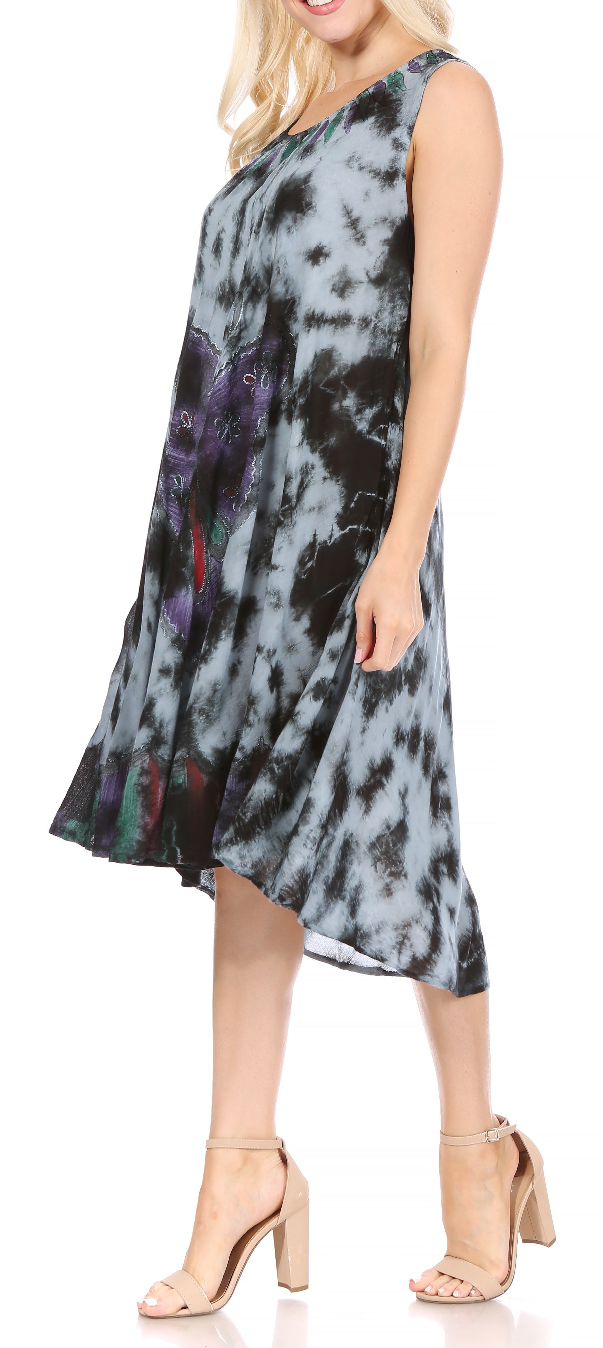 Woman wearing a sleeveless dress with tie-dye pattern on a plain background