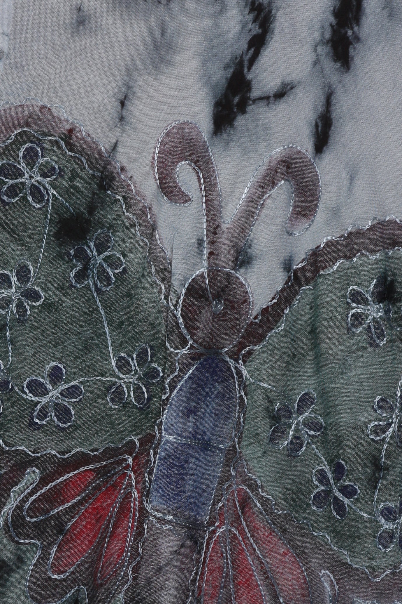 Close-up of a butterfly with floral patterns on a textured fabric background