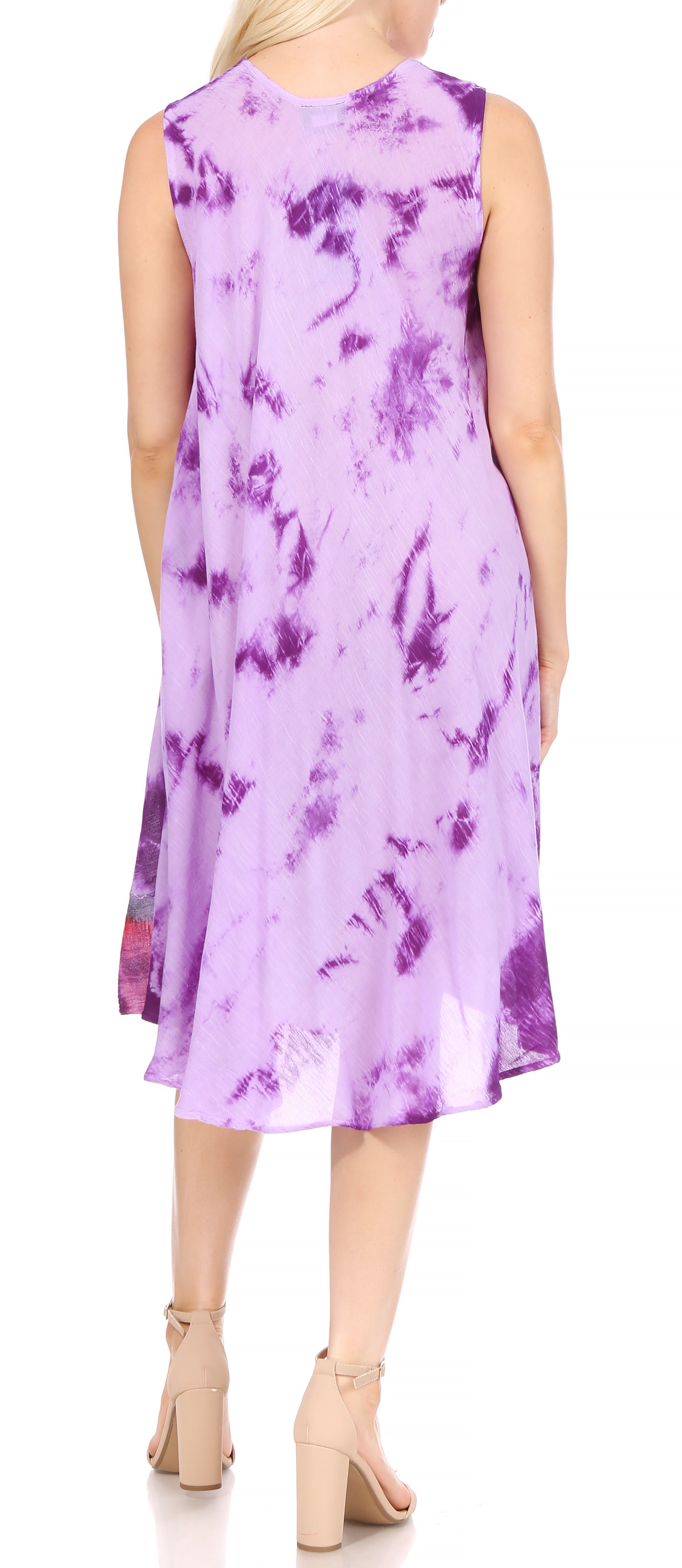 Woman wearing a sleeveless purple dress with floral patterns on a white background