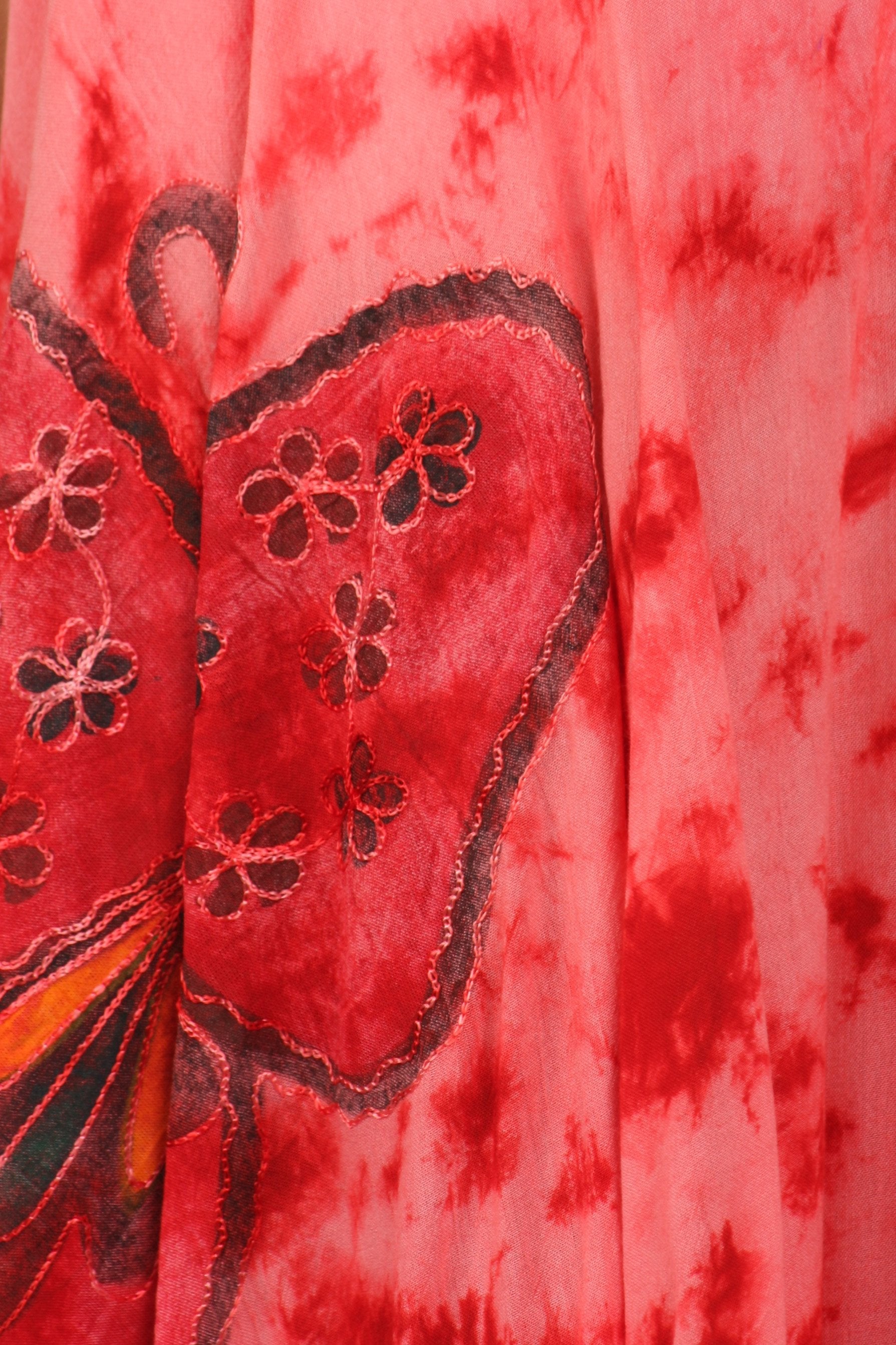 Red fabric with butterfly design and floral patterns
