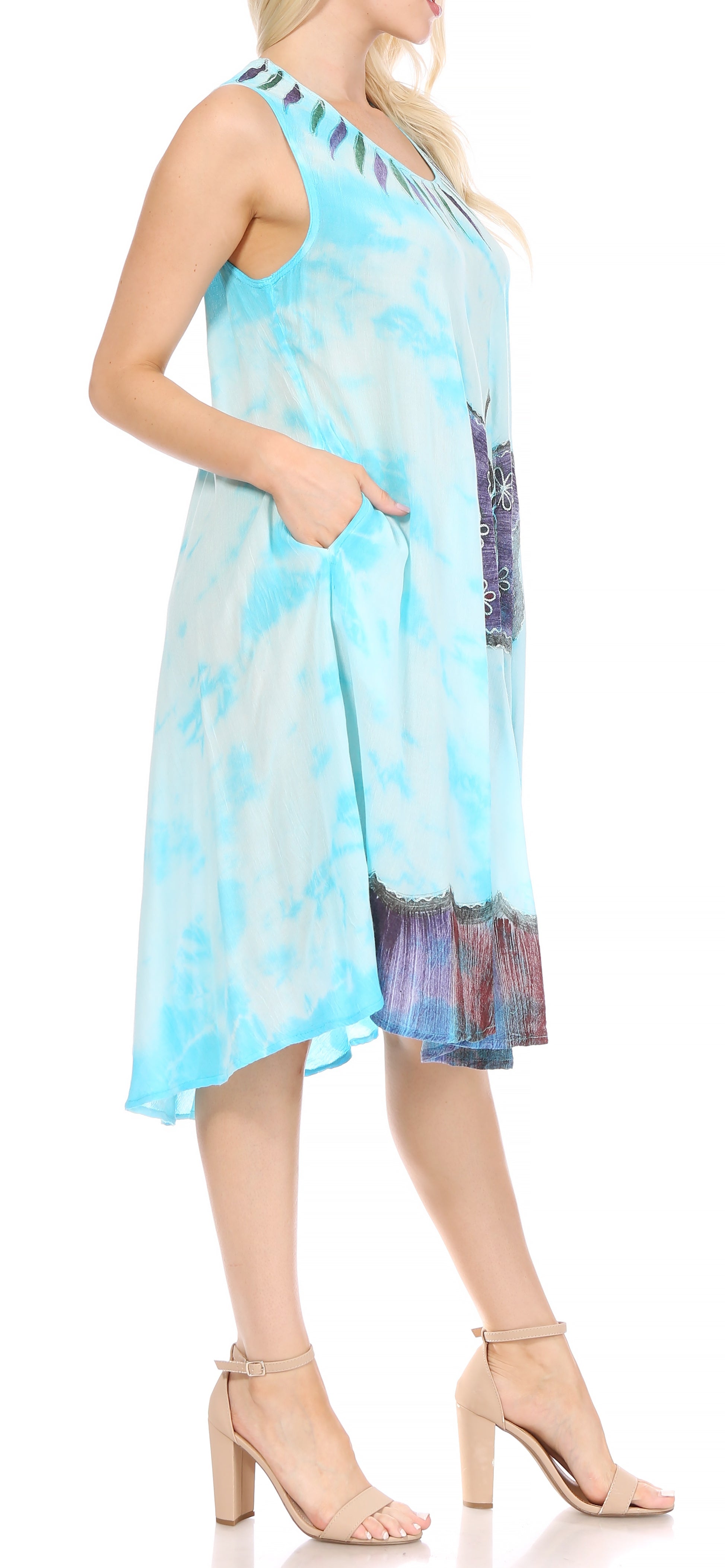 Woman wearing a blue tie-dye dress with a blurred background