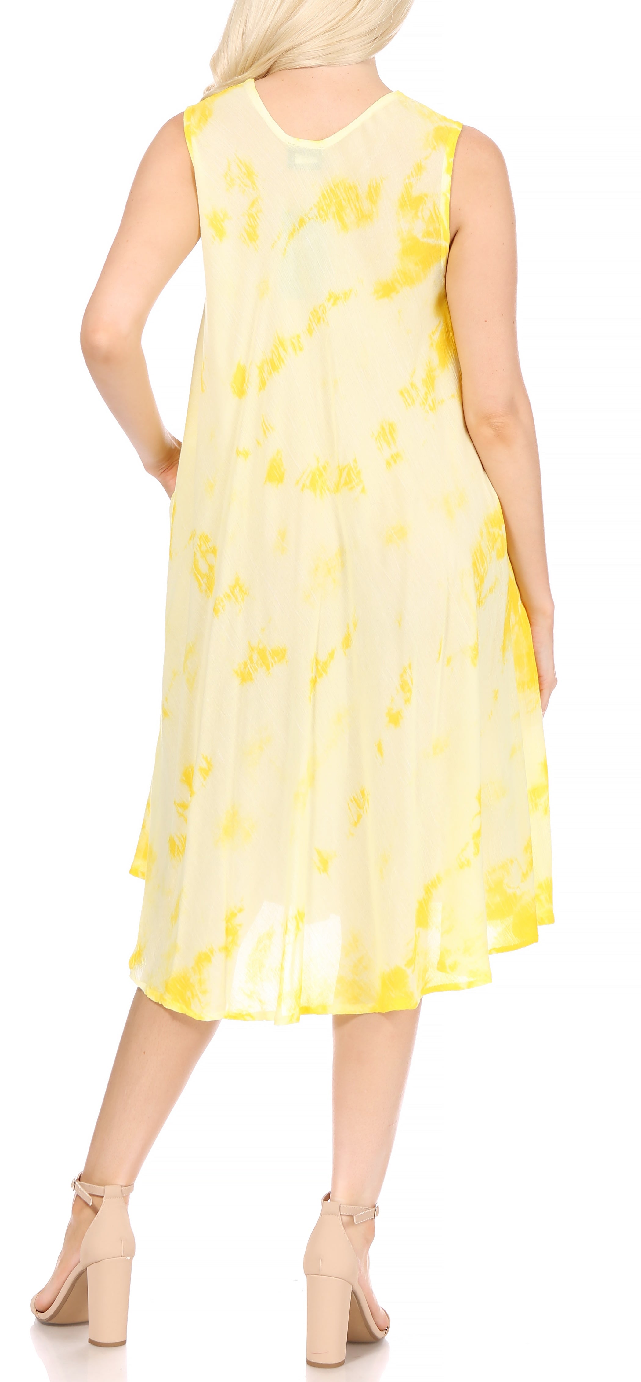 Woman wearing a yellow sleeveless dress with floral pattern on a white background