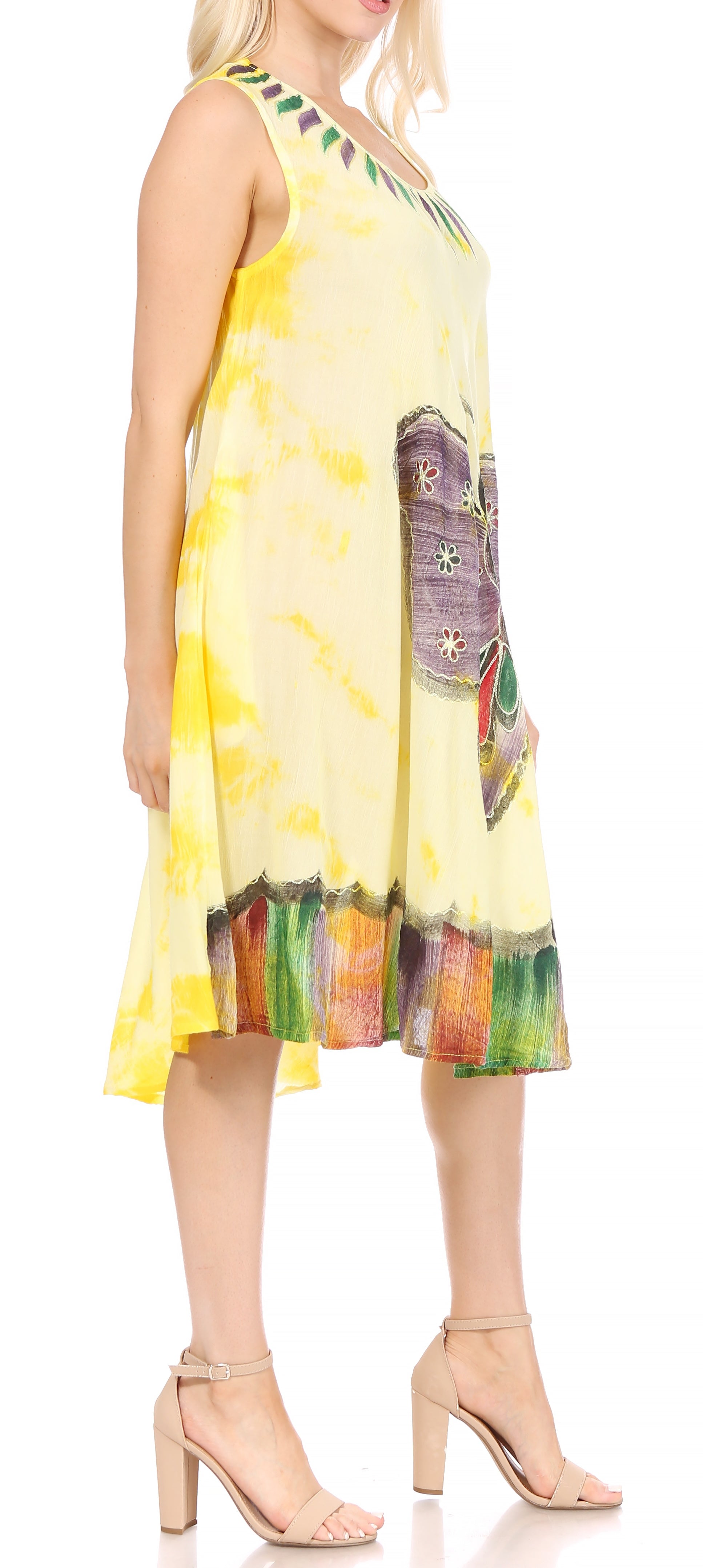 Woman wearing a yellow dress with colorful pattern on a white background