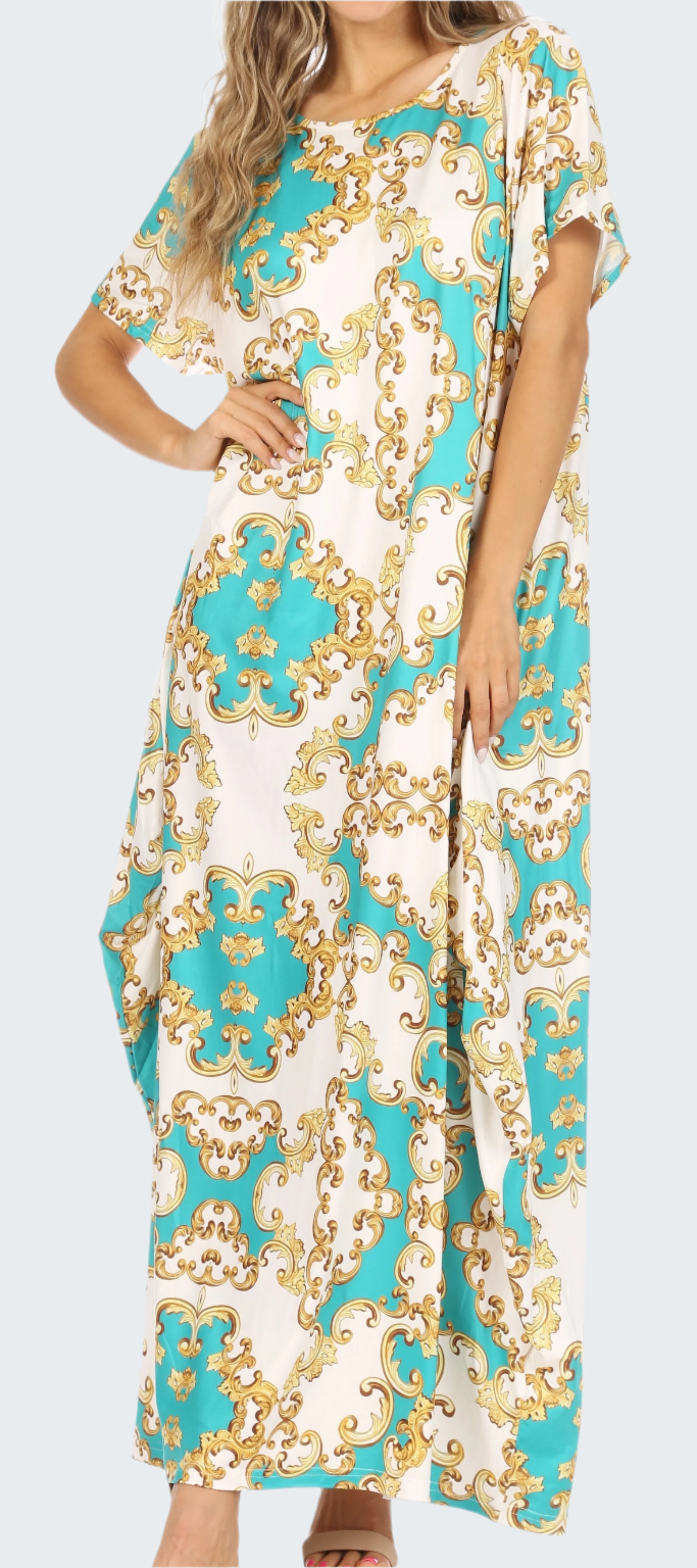 Woman wearing a floral patterned dress with turquoise and gold design.