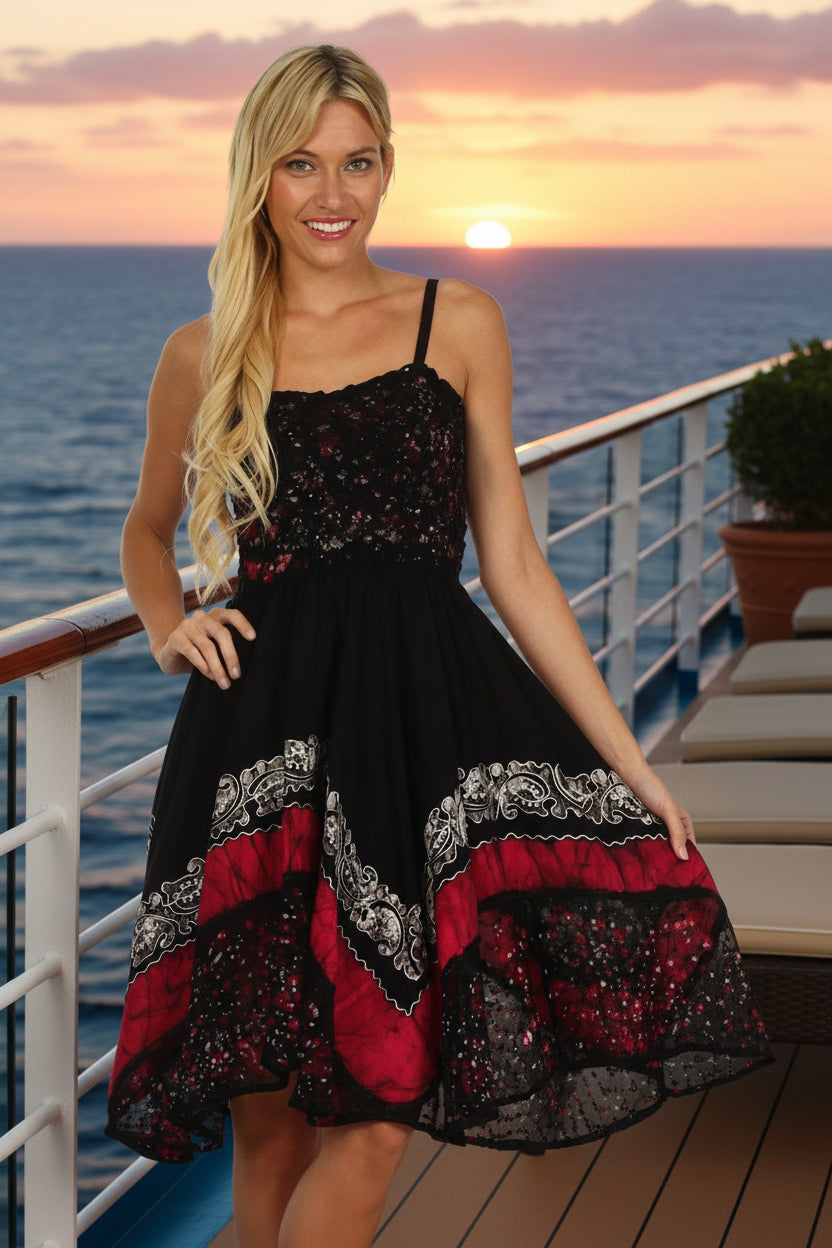 Woman wearing a black, red, and white patterned dress on a white background