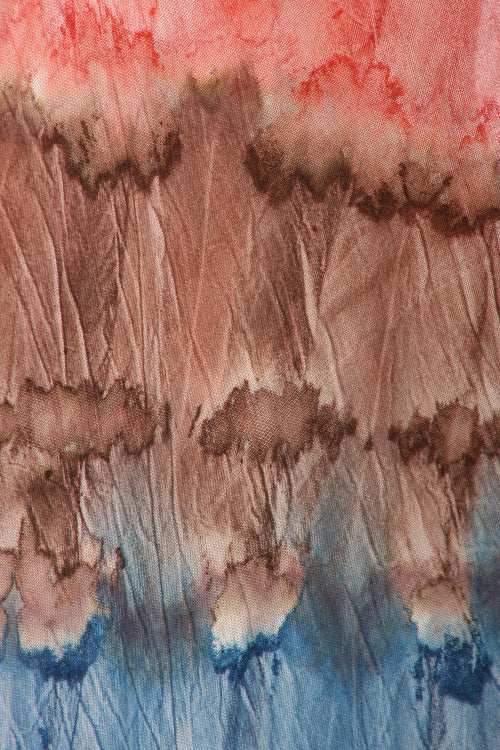 Abstract watercolor pattern with brown, red, and blue hues