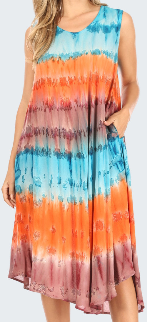 Woman wearing a tie-dye dress with orange, blue, and pink colors.
