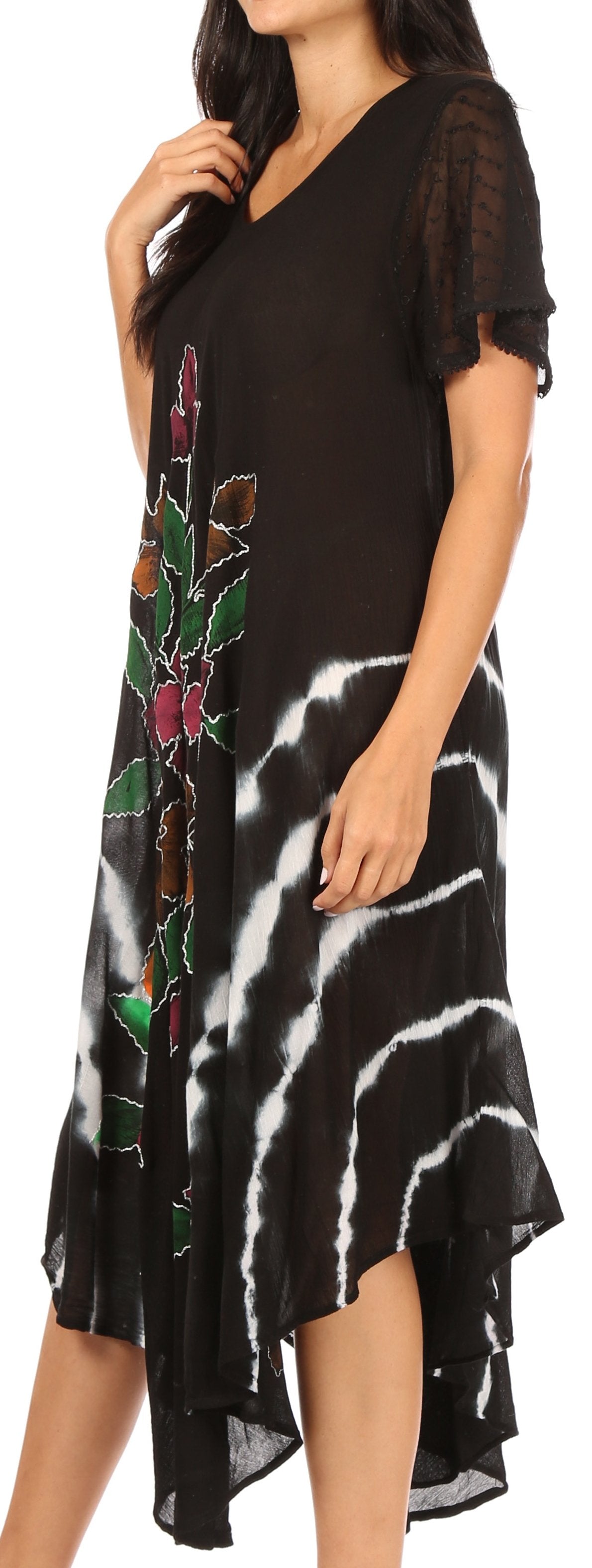 Black dress with white abstract pattern and floral embroidery on a plain background