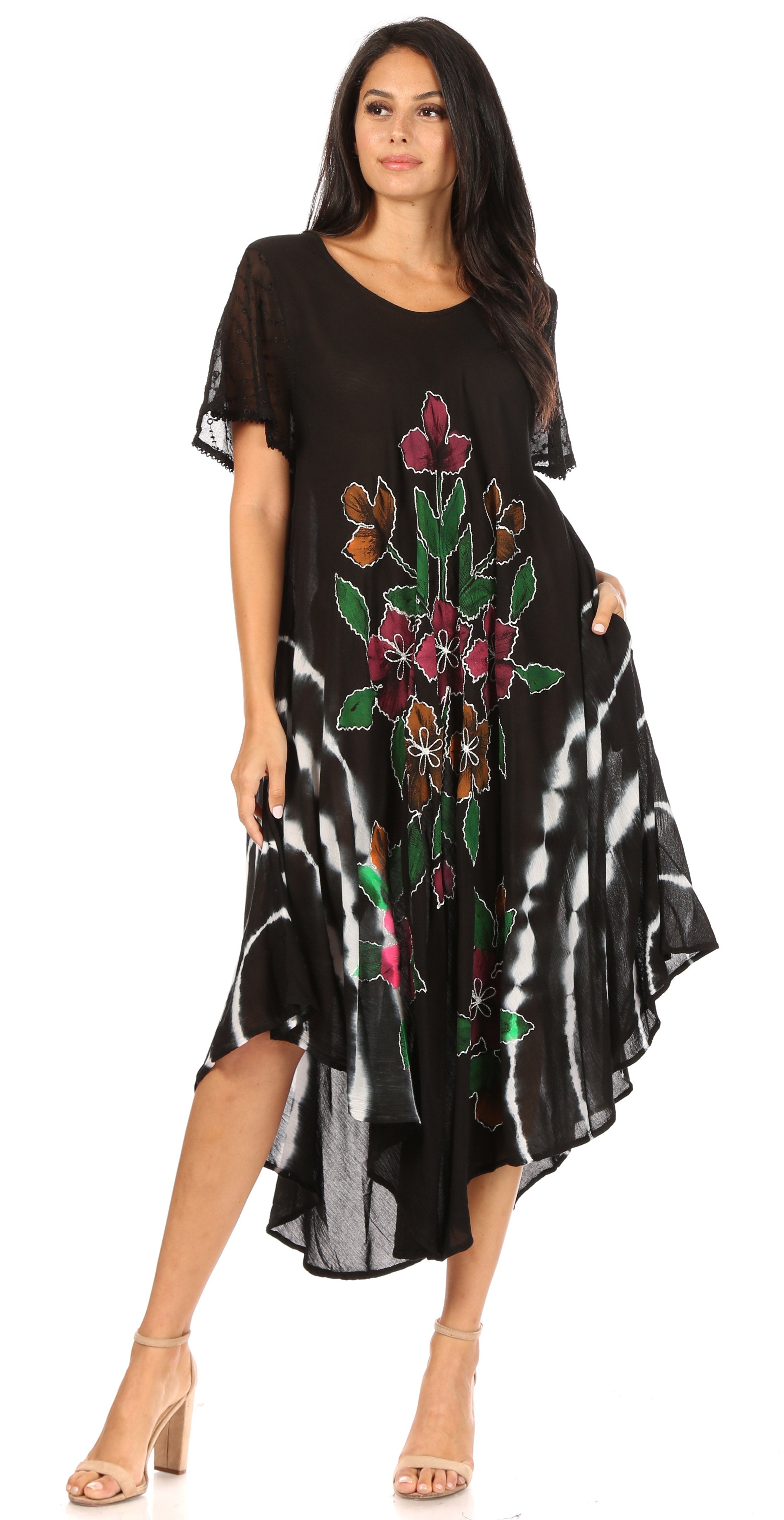 Woman wearing a black dress with floral embroidery on a white background