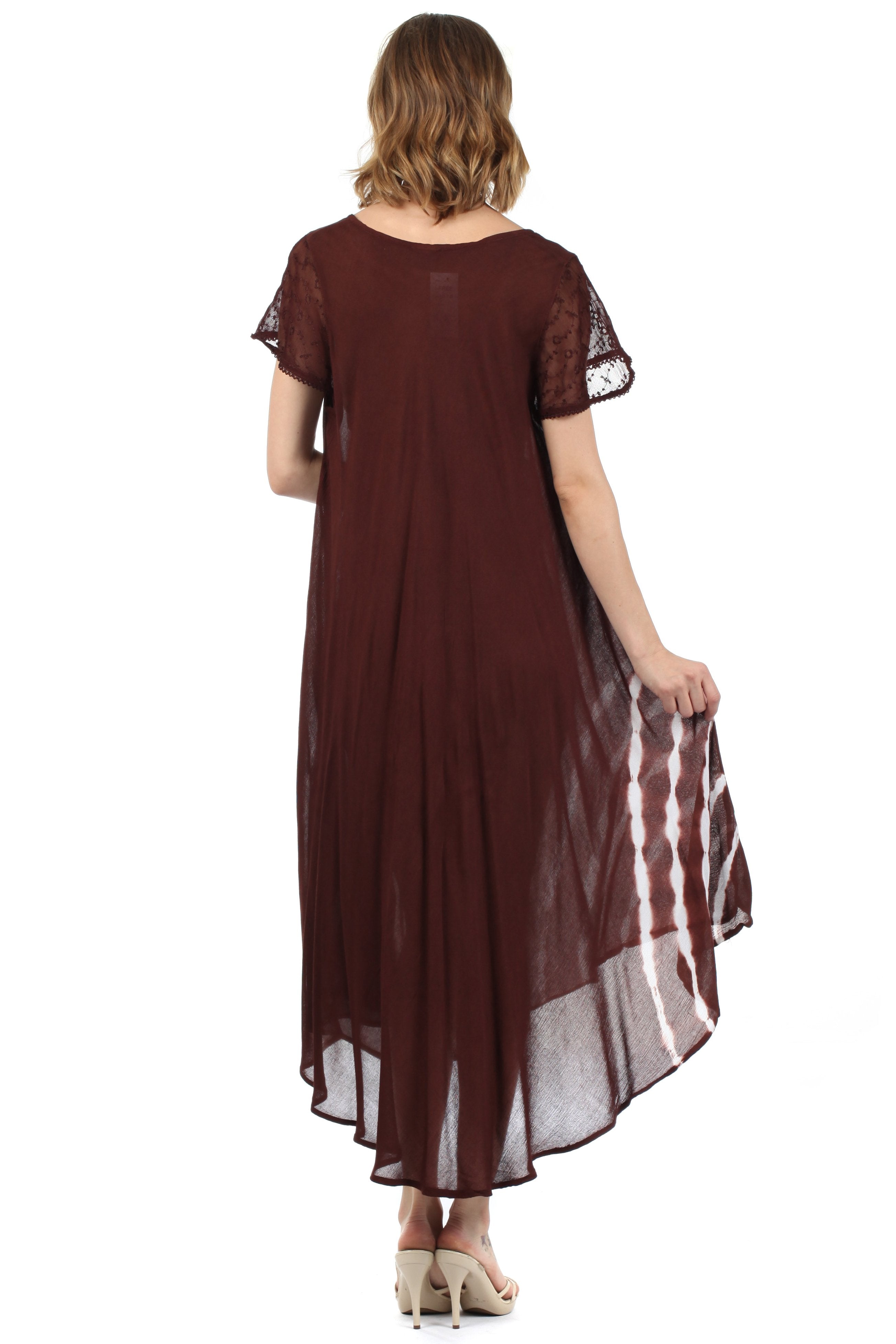 Woman wearing a burgundy dress with sheer sleeves on a white background