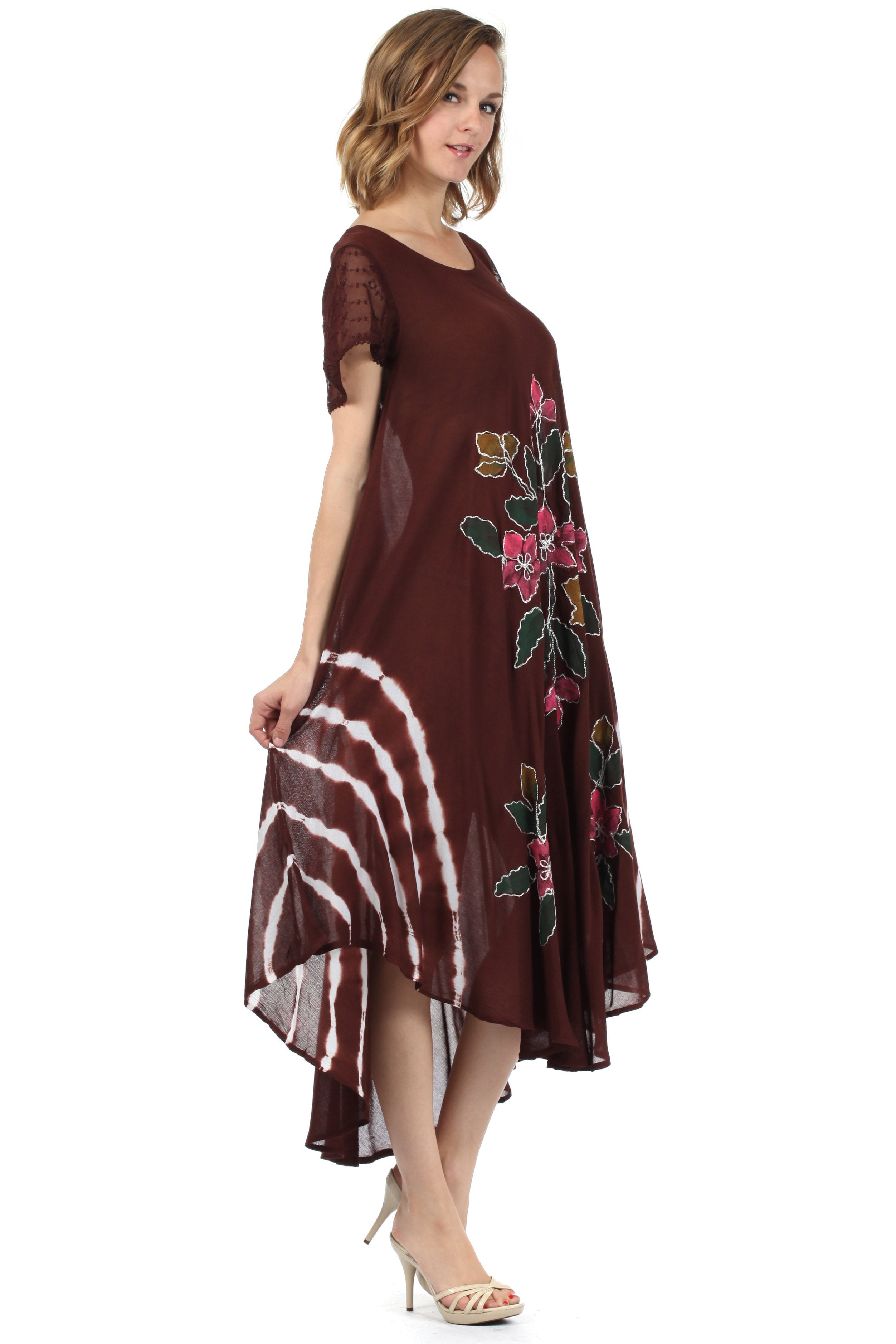 Woman wearing a brown dress with floral embroidery on a white background