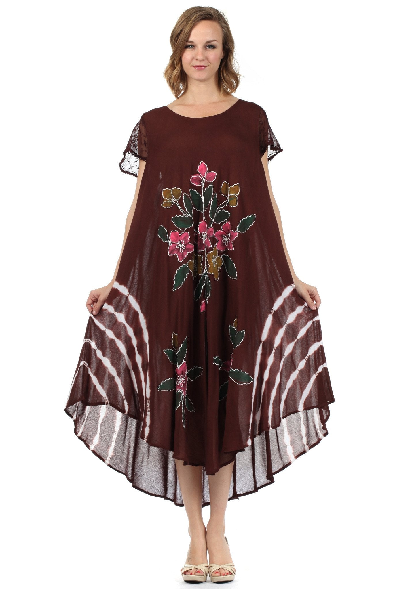 Woman wearing a brown dress with floral embroidery on a white background