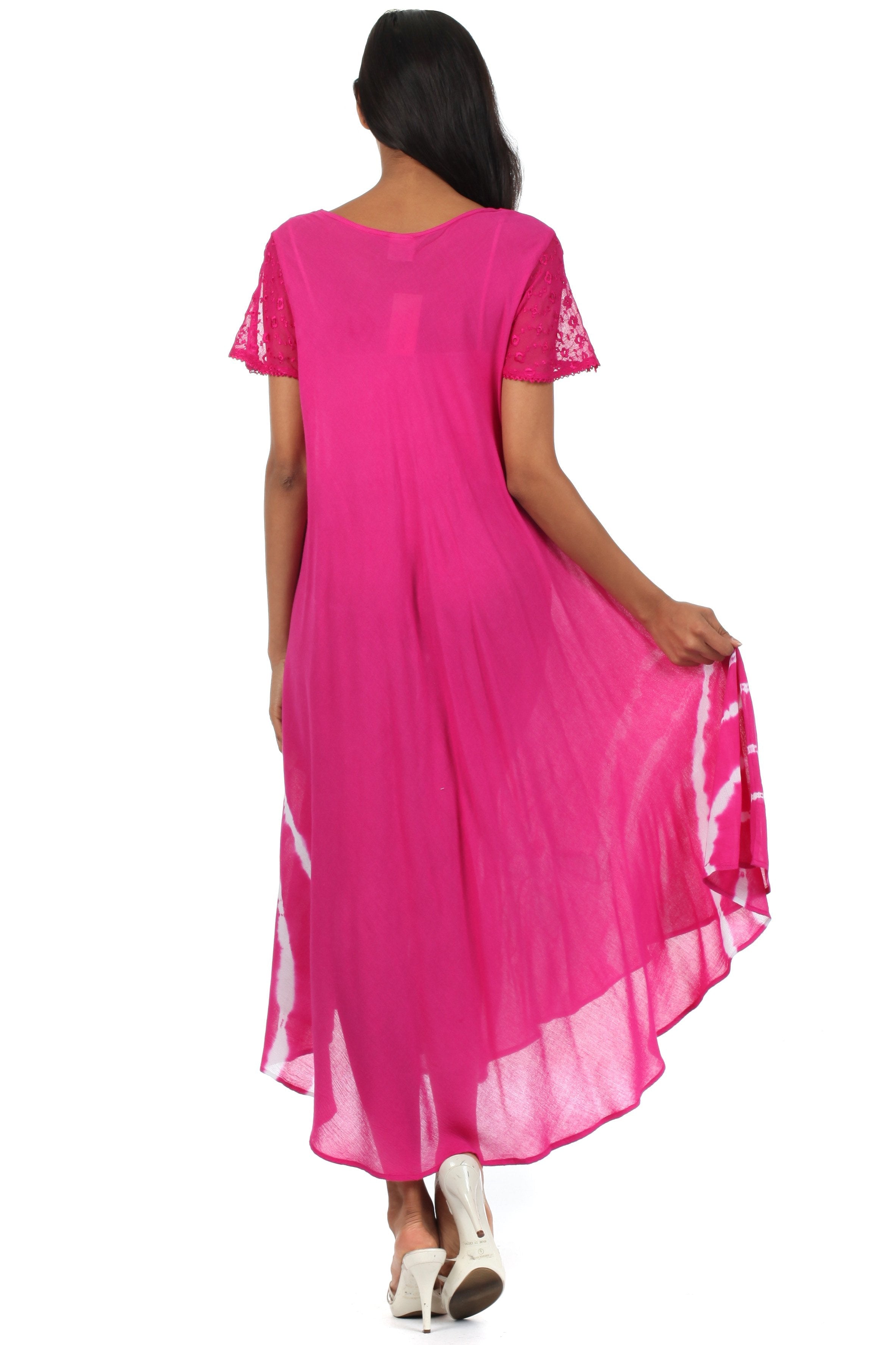 Woman wearing a pink dress with lace sleeves on a white background