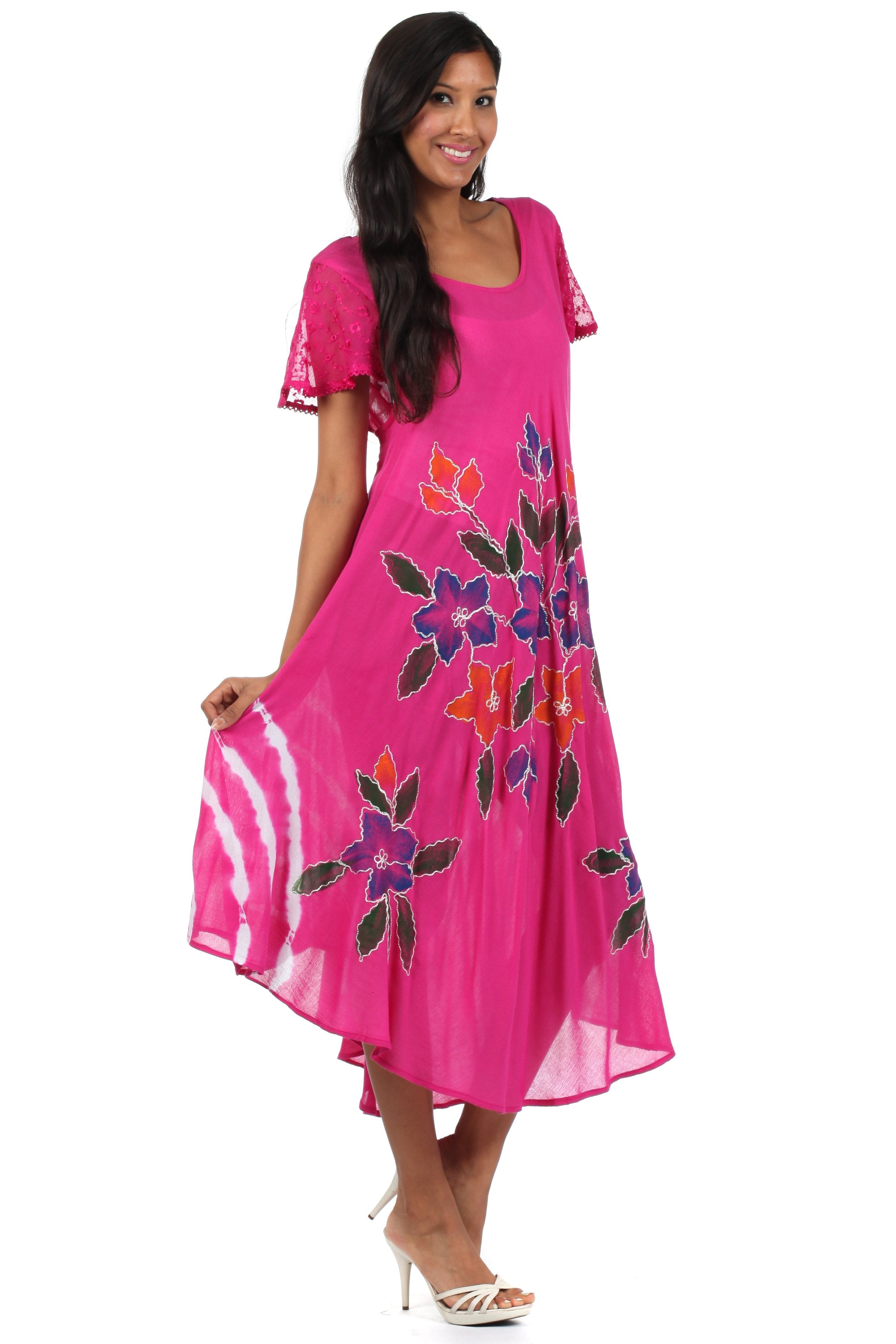 Woman wearing a pink dress with floral patterns on a white background