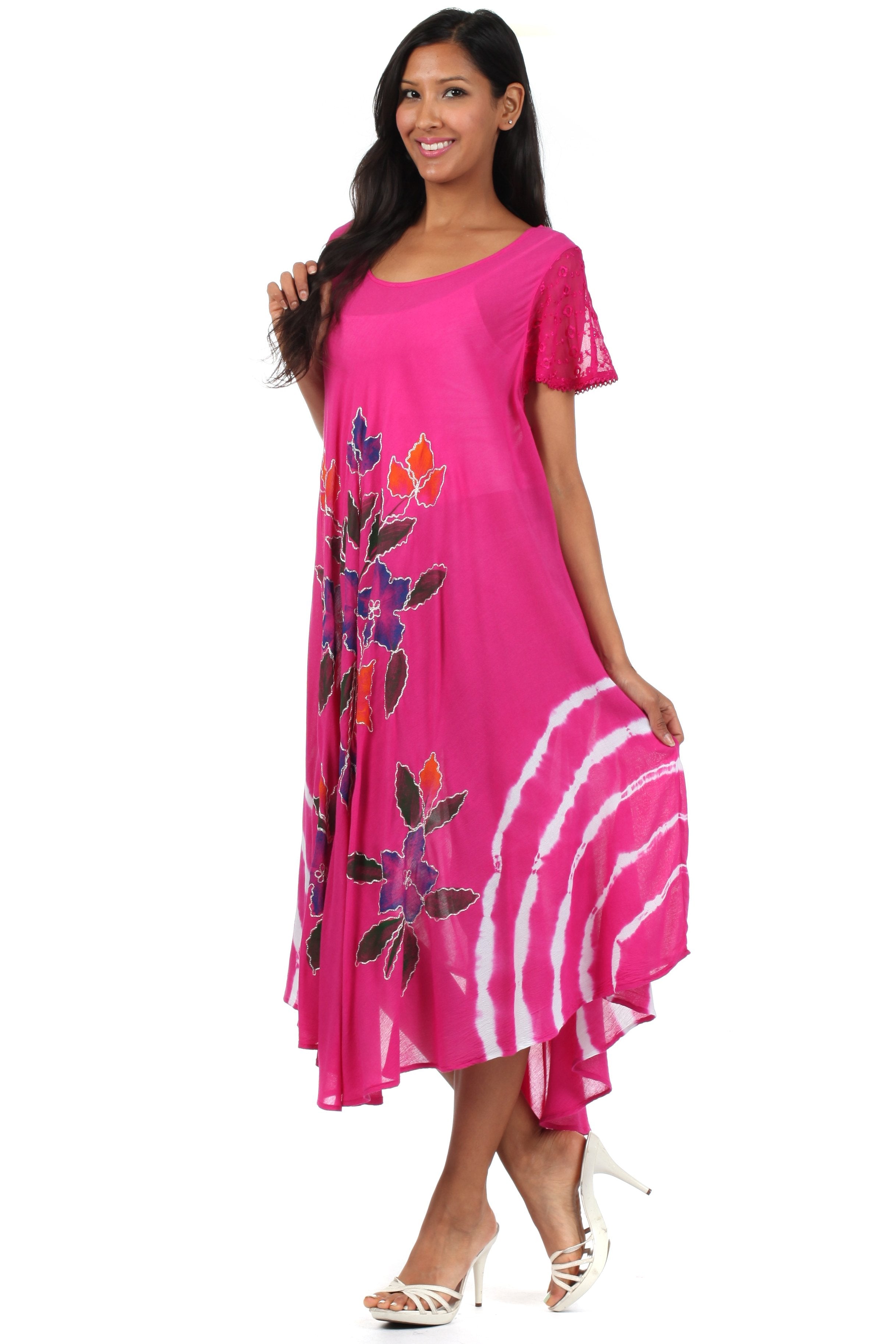 Woman wearing a pink dress with floral design on a white background
