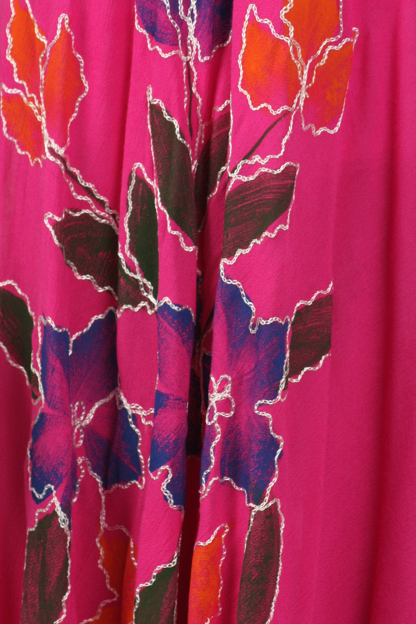 Close-up of a pink fabric with colorful leaf pattern