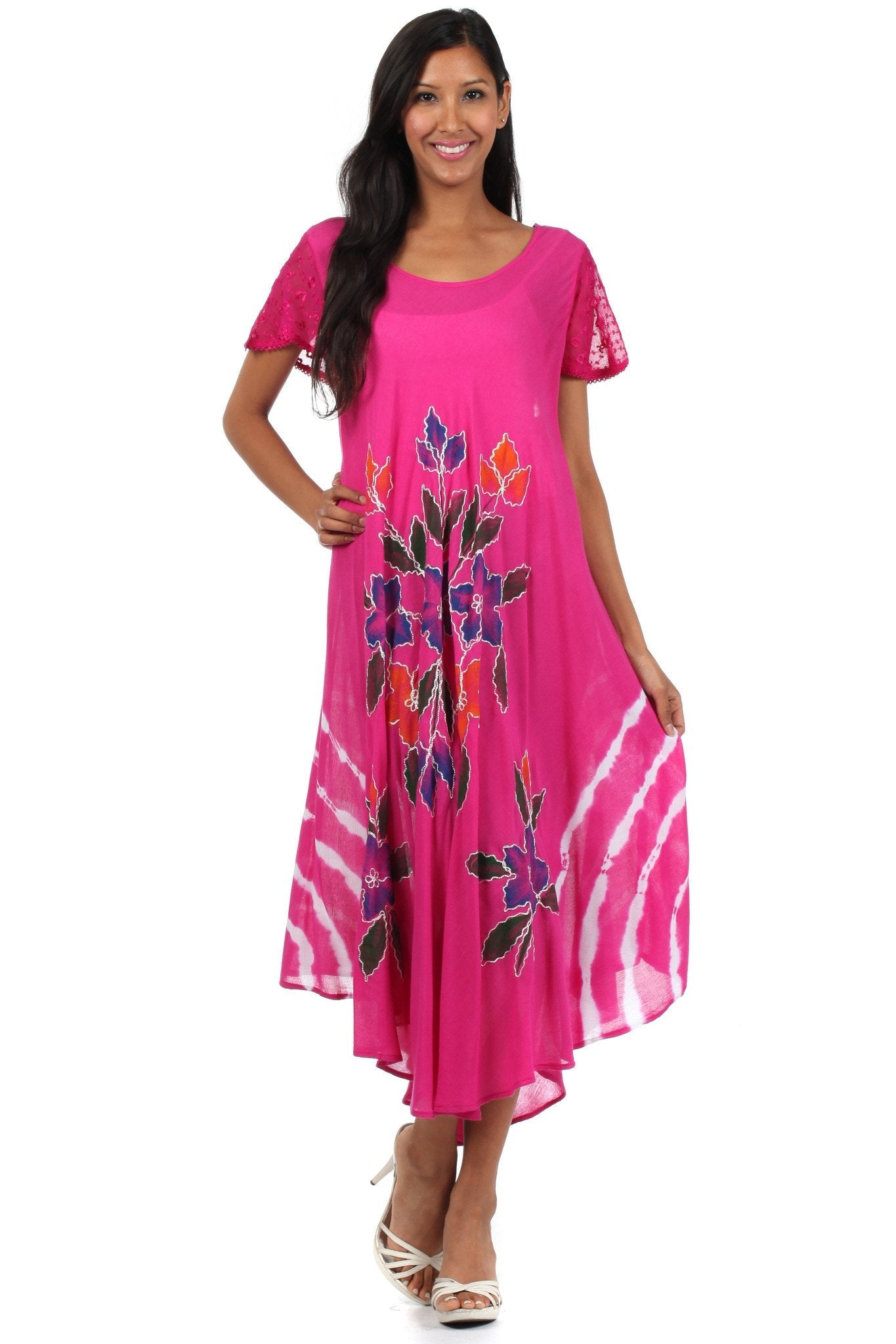 Woman wearing a pink dress with floral patterns on a white background