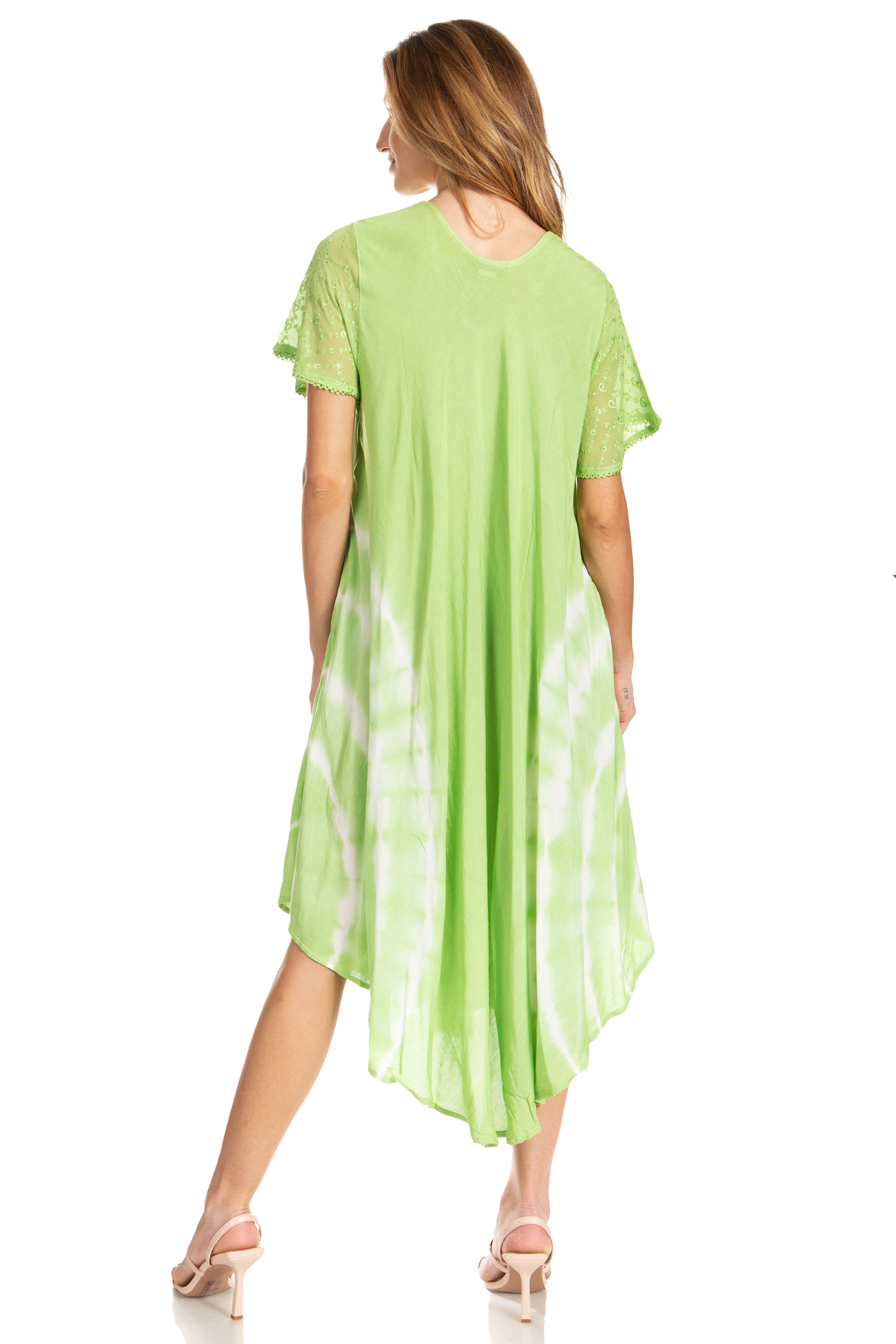 Woman wearing a green dress with white polka dots on a white background