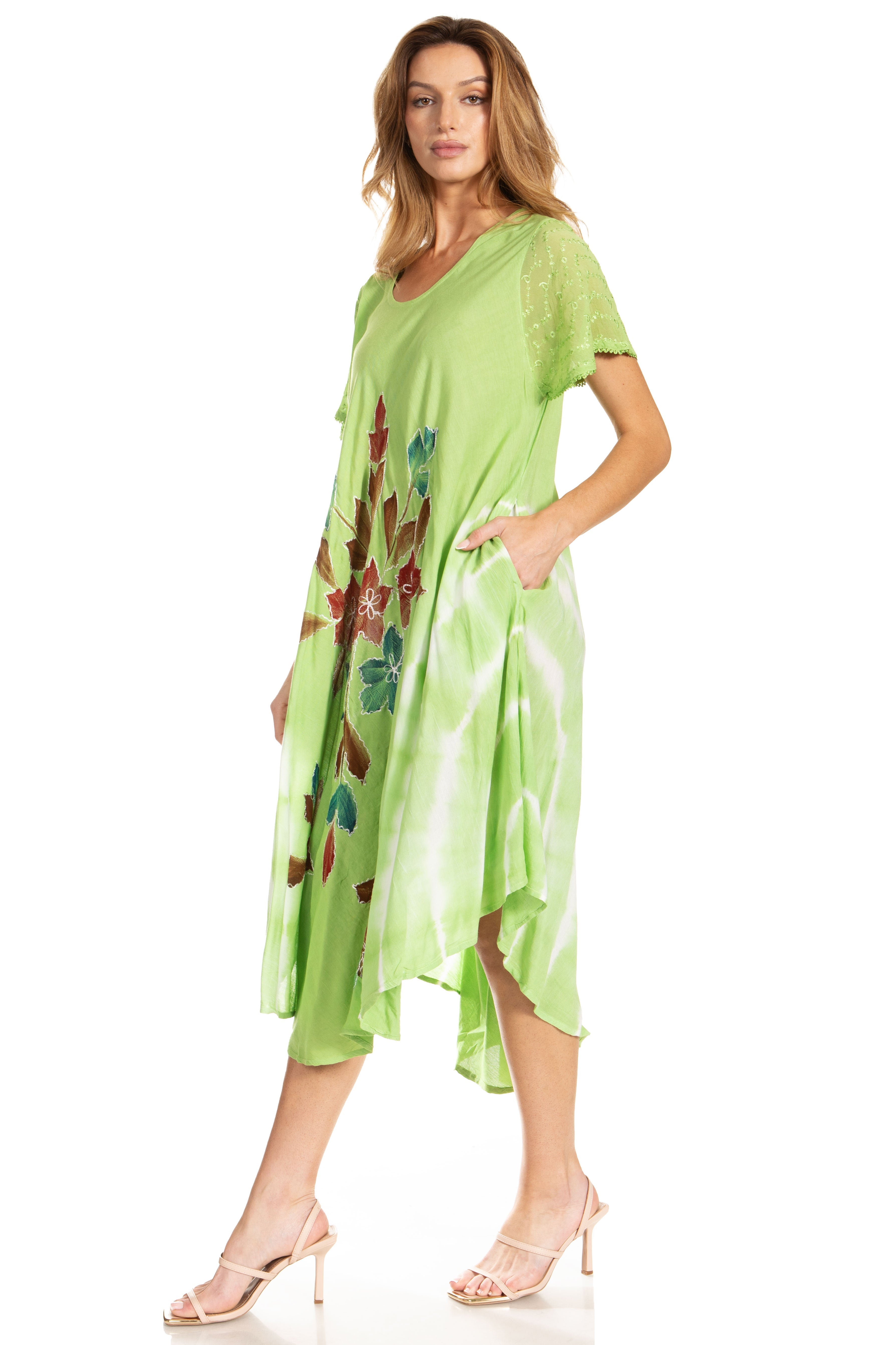 Woman wearing a green dress with floral patterns on a white background